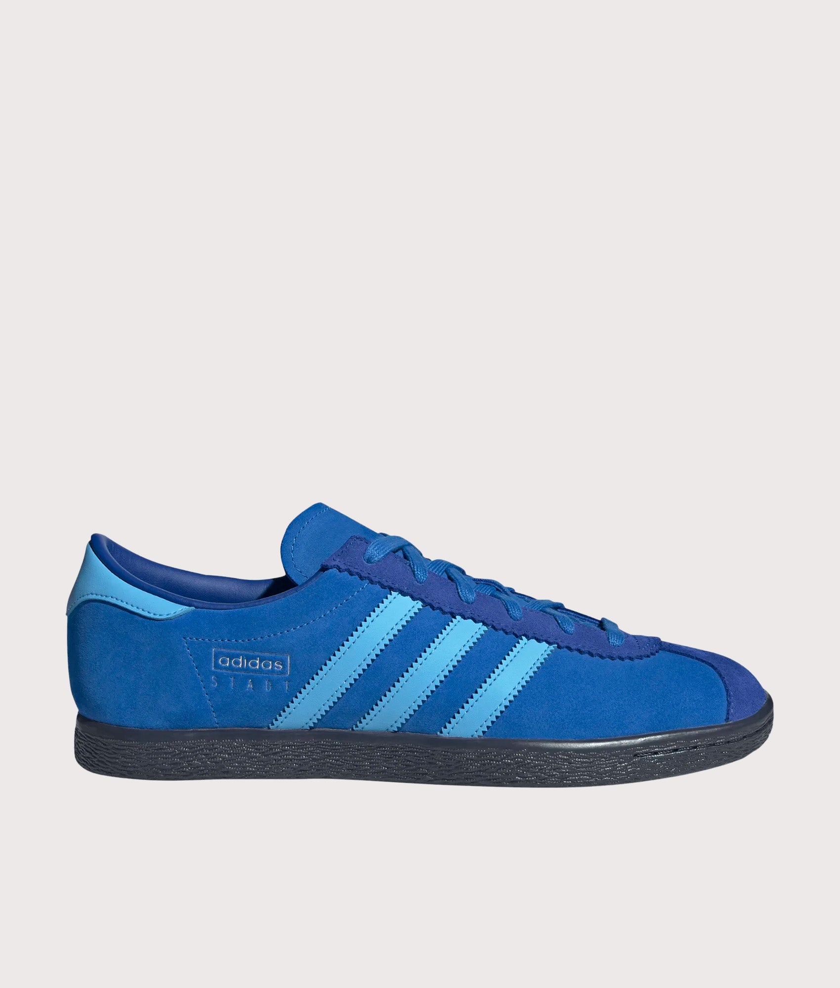 adidas Originals Stadt Trainers in Bright Royal, Semi Blue Burst and Shadow Navy at EQVVS Menswear. Side shot.