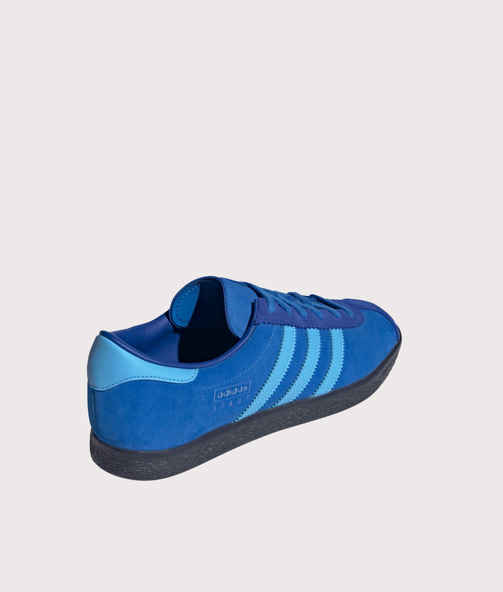 adidas Originals Stadt Trainers in Bright Royal, Semi Blue Burst and Shadow Navy at EQVVS Menswear. Angled back shot.