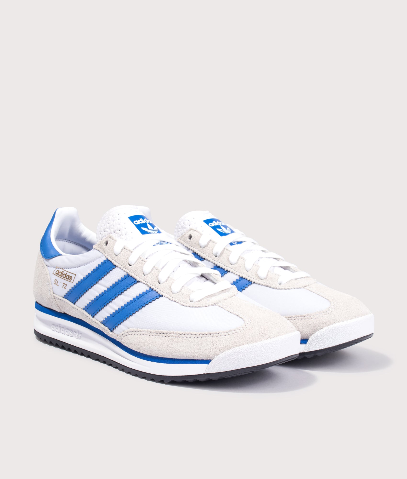 adidas Originals SL 72 RS Trainers in Footwear White, Blue and Core Black at EQVVS Menswear. Angled front shot.