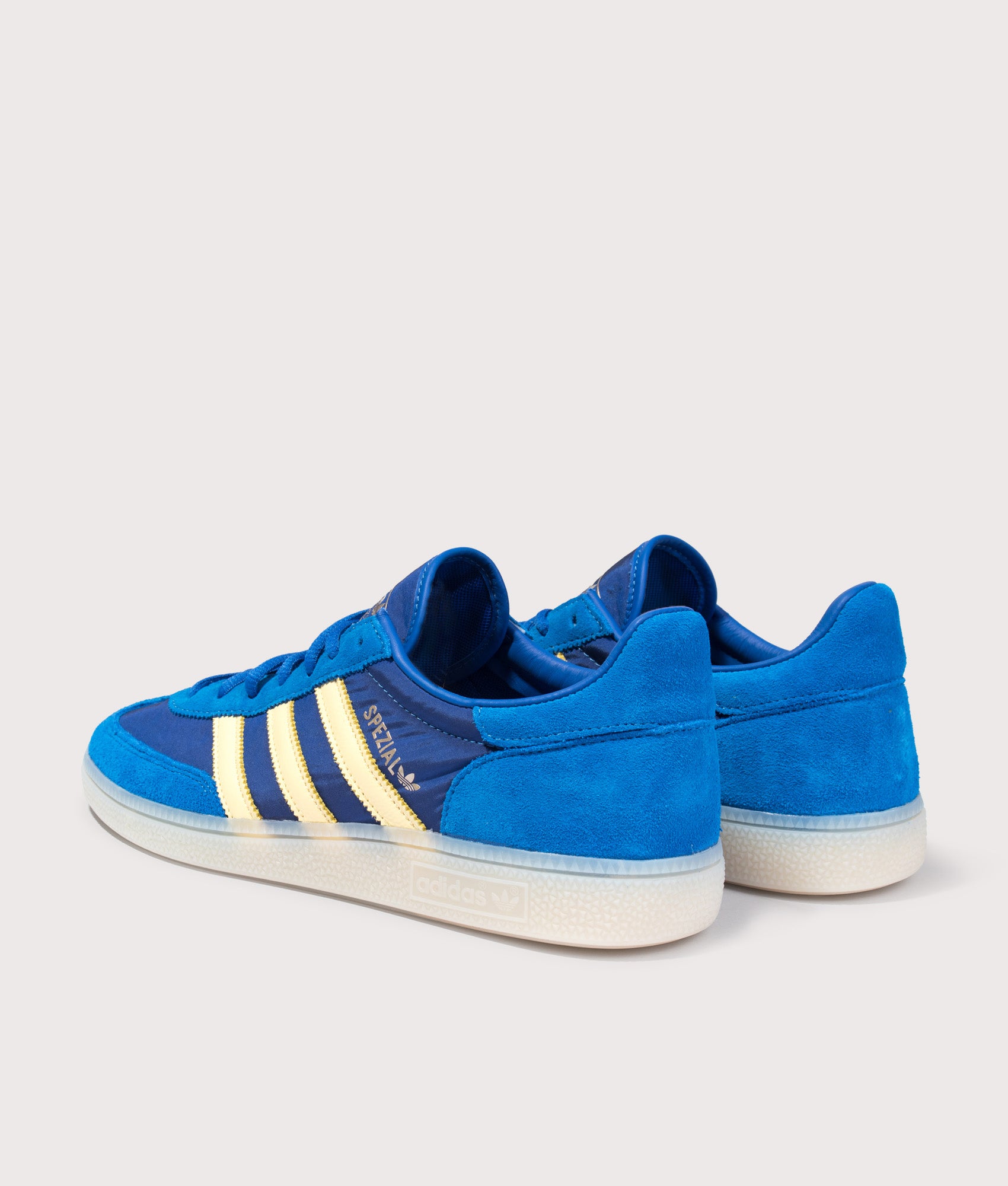 adidas Originals Handball Spezial Trainers in Equipment Blue, Almost Yellow and Off White at EQVVS Menswear. Angled back shot.