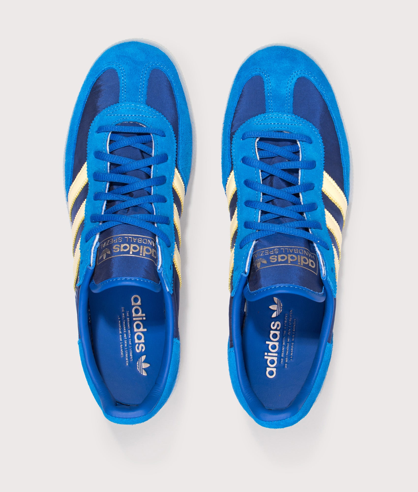 adidas Originals Handball Spezial Trainers in Equipment Blue, Almost Yellow and Off White at EQVVS Menswear. Top shot.