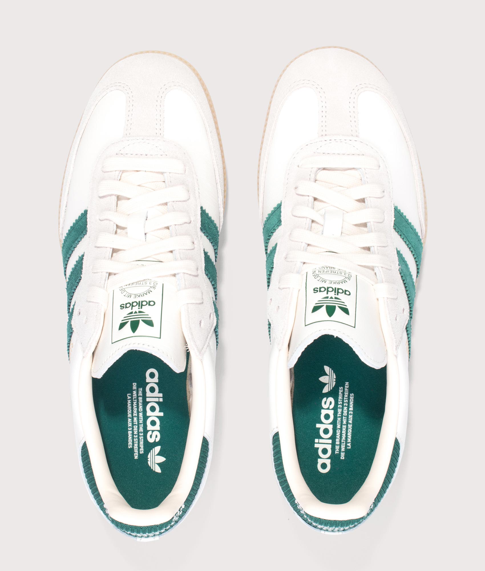 Samba OG Trainers in Cloud White/Collegiate Green/Gum by adidas. Shot by EQVVS. Arial shot.