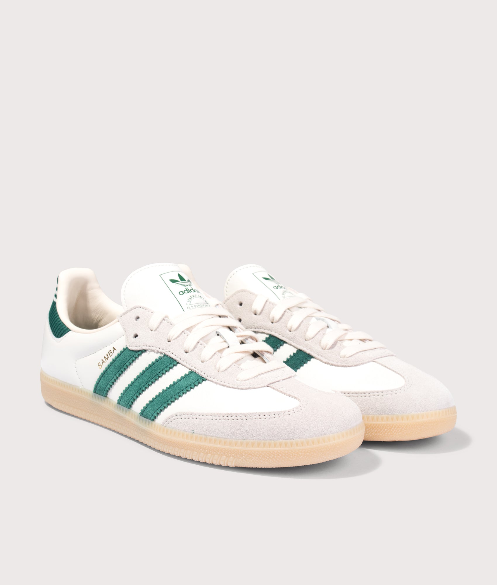 Samba OG Trainers in Cloud White/Collegiate Green/Gum by adidas. Shot by EQVVS. Front angled shot.