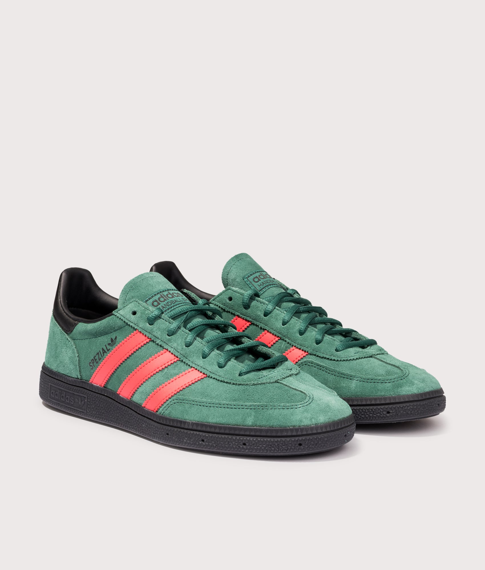adidas Originals Handball Spezial Trainers in Collegiate Green, Red and Core Black at EQVVS Menswear. Angled front shot.