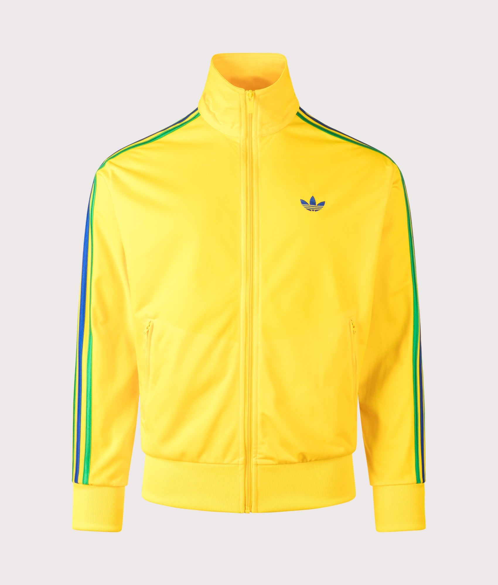 adidas Originals Loose Fit Firebird Track Top in Eqt Yellow, Green and Collegiate Royal at EQVVS Menswear. Front shot.