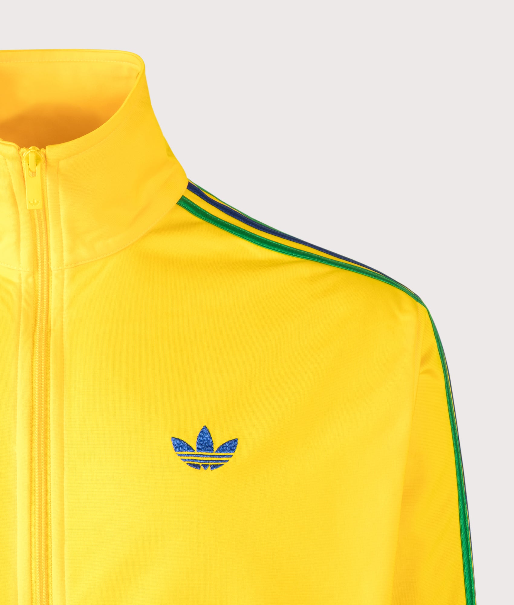adidas Originals Loose Fit Firebird Track Top in Eqt Yellow, Green and Collegiate Royal at EQVVS Menswear. Detail shot.