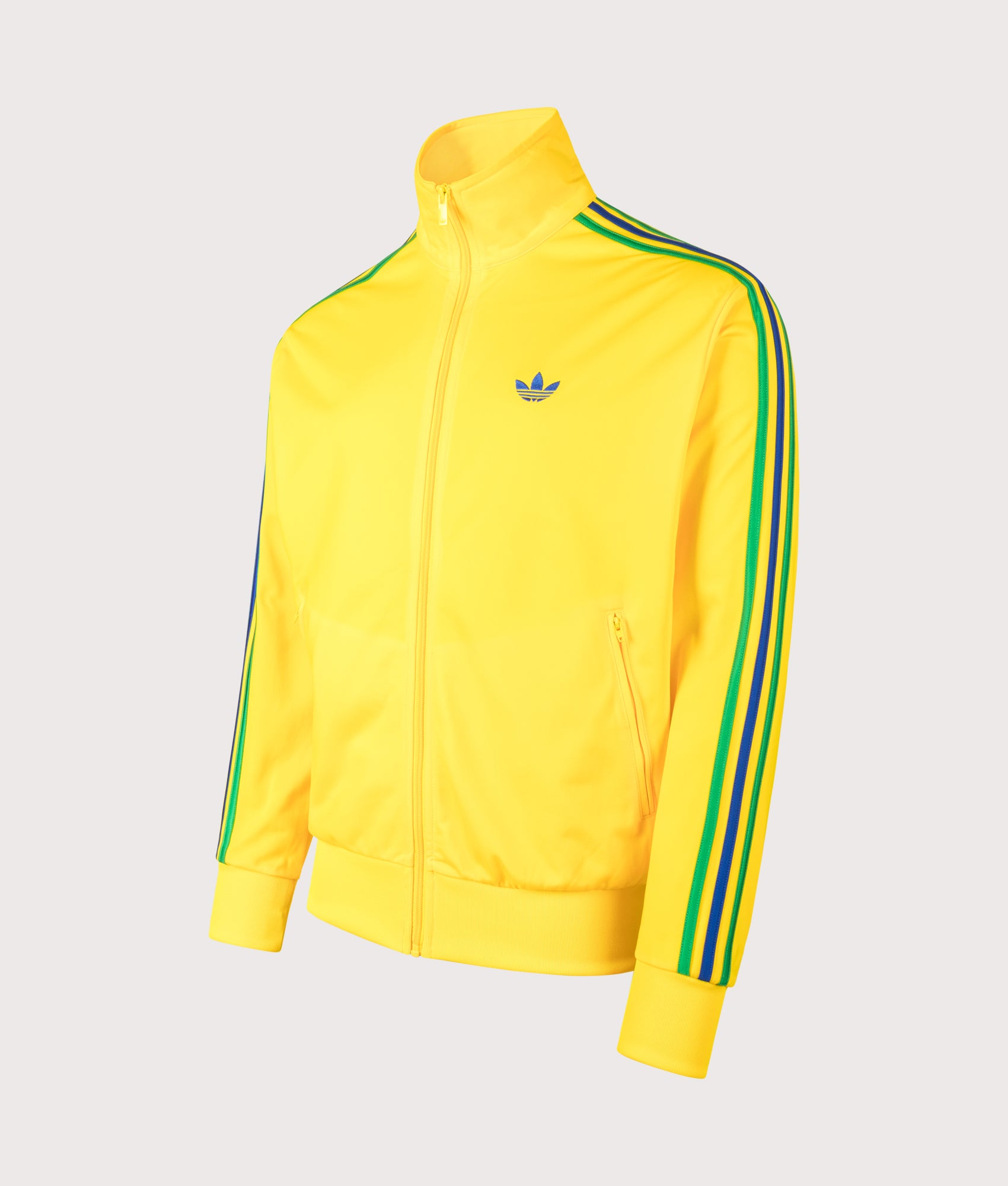adidas Originals Loose Fit Firebird Track Top in Eqt Yellow, Green and Collegiate Royal at EQVVS Menswear. Angled front shot.