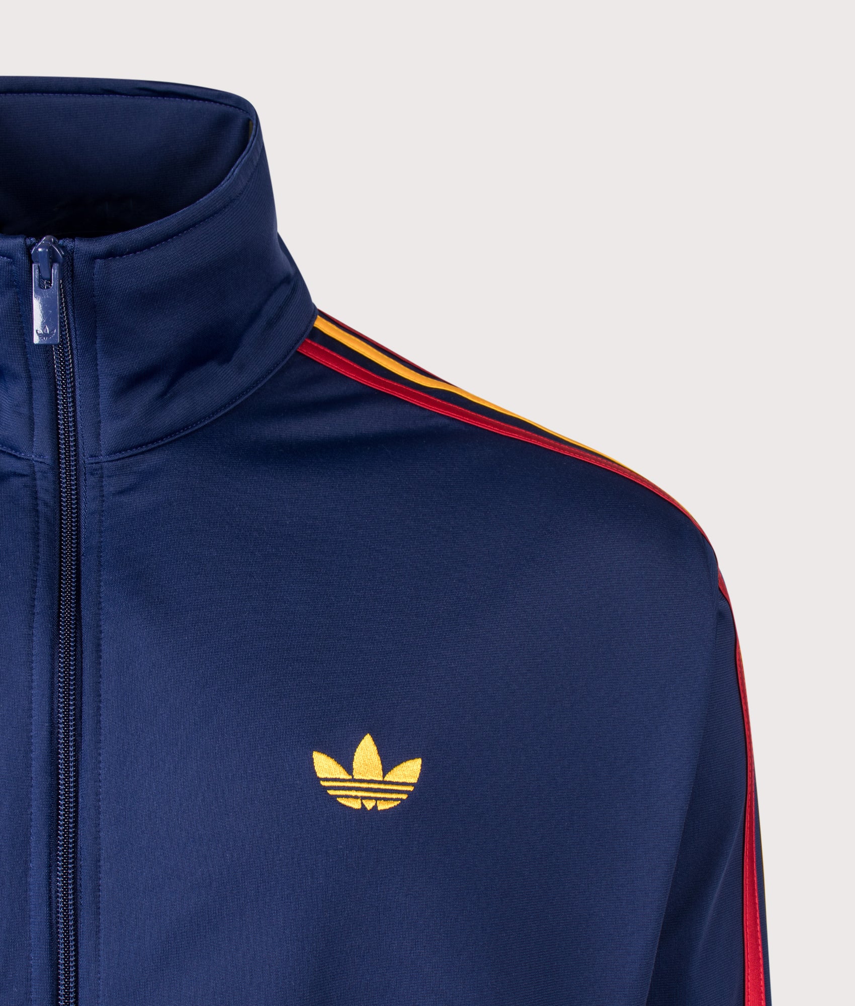 Loose Fit Firebird Track Top in Dark Blue/Crew Yellow/Team Power Red by adidas Originals. Shot by EQVVS. Detail shot.
