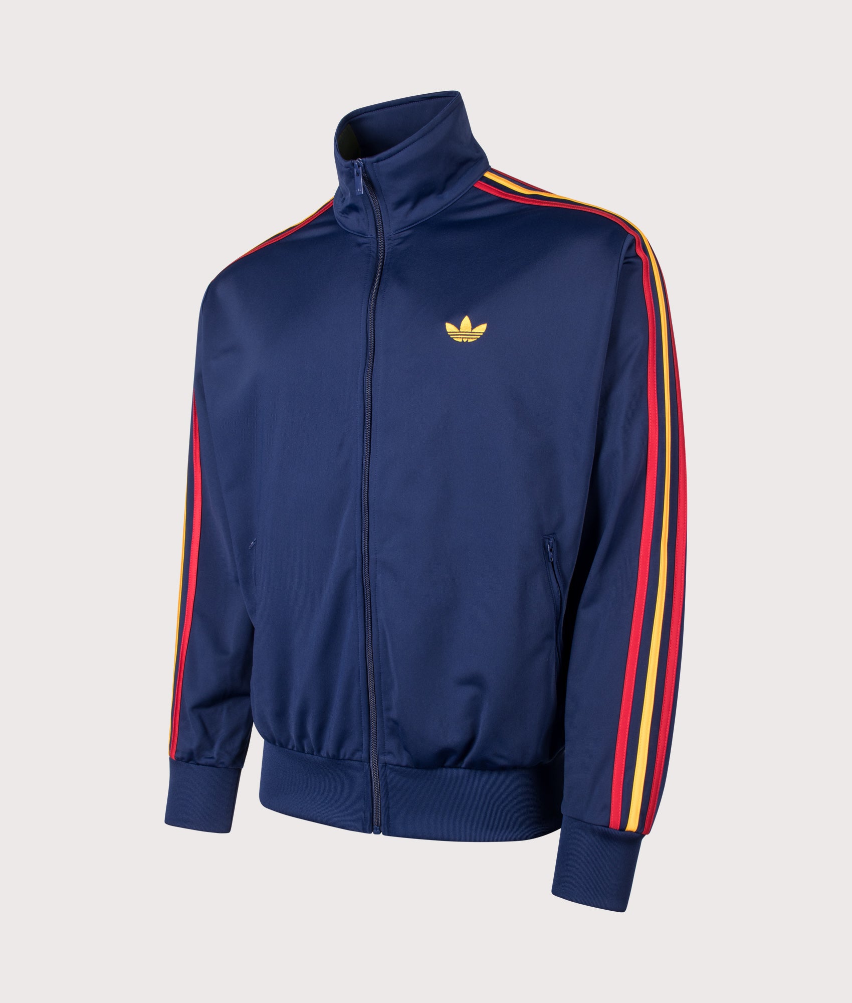 Loose Fit Firebird Track Top in Dark Blue/Crew Yellow/Team Power Red by adidas Originals. Shot by EQVVS. Front angled shot.