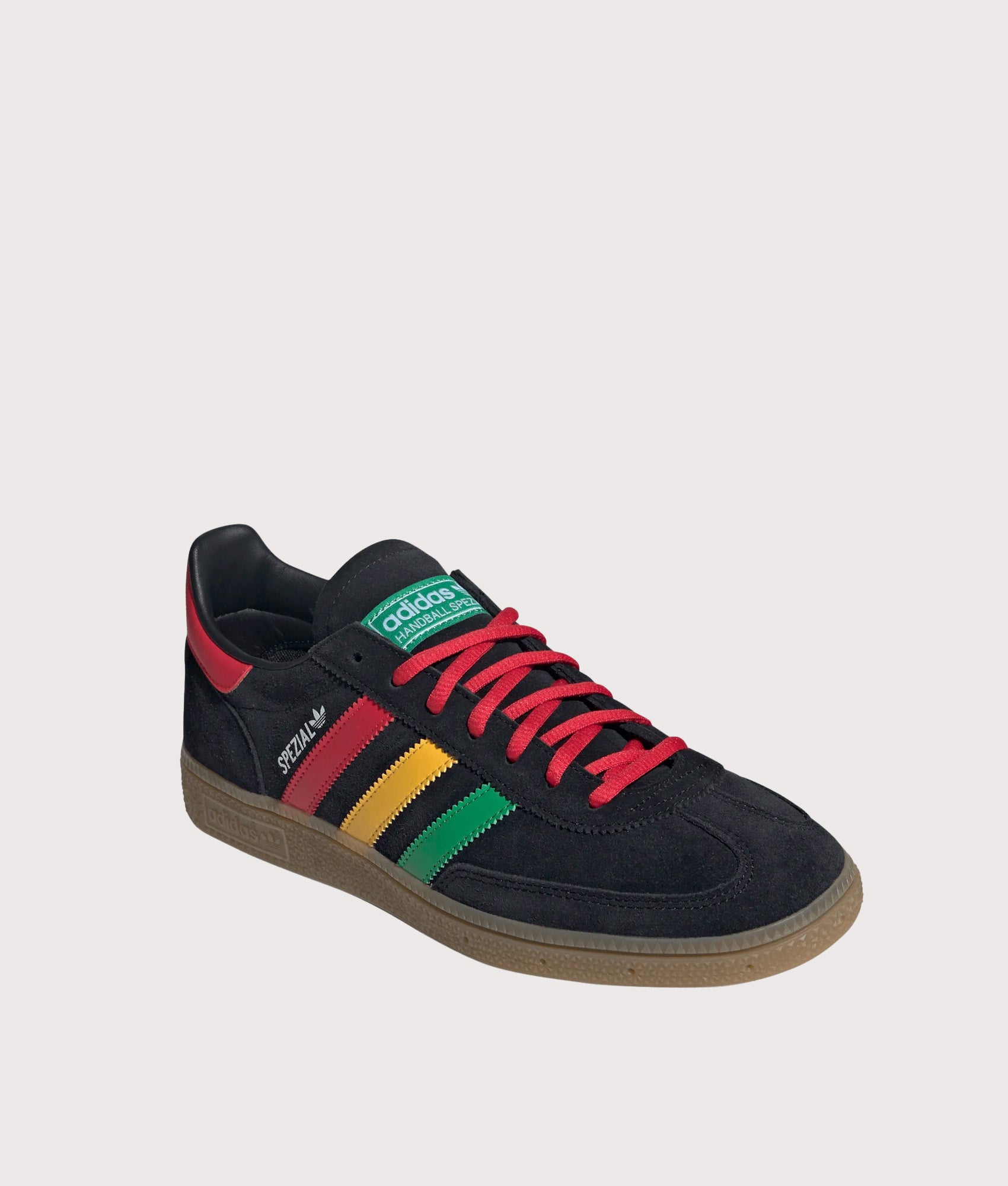 adidas Originals Jamaica X Bob Marley Handball Spezial Trainers in core Black, Pure Ruby and Bold Gold at EQVVS Menswear. Angled front shot.