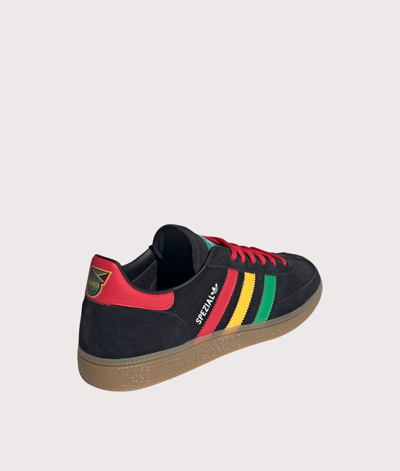 adidas Originals Jamaica X Bob Marley Handball Spezial Trainers in core Black, Pure Ruby and Bold Gold at EQVVS Menswear. Angled back shot.
