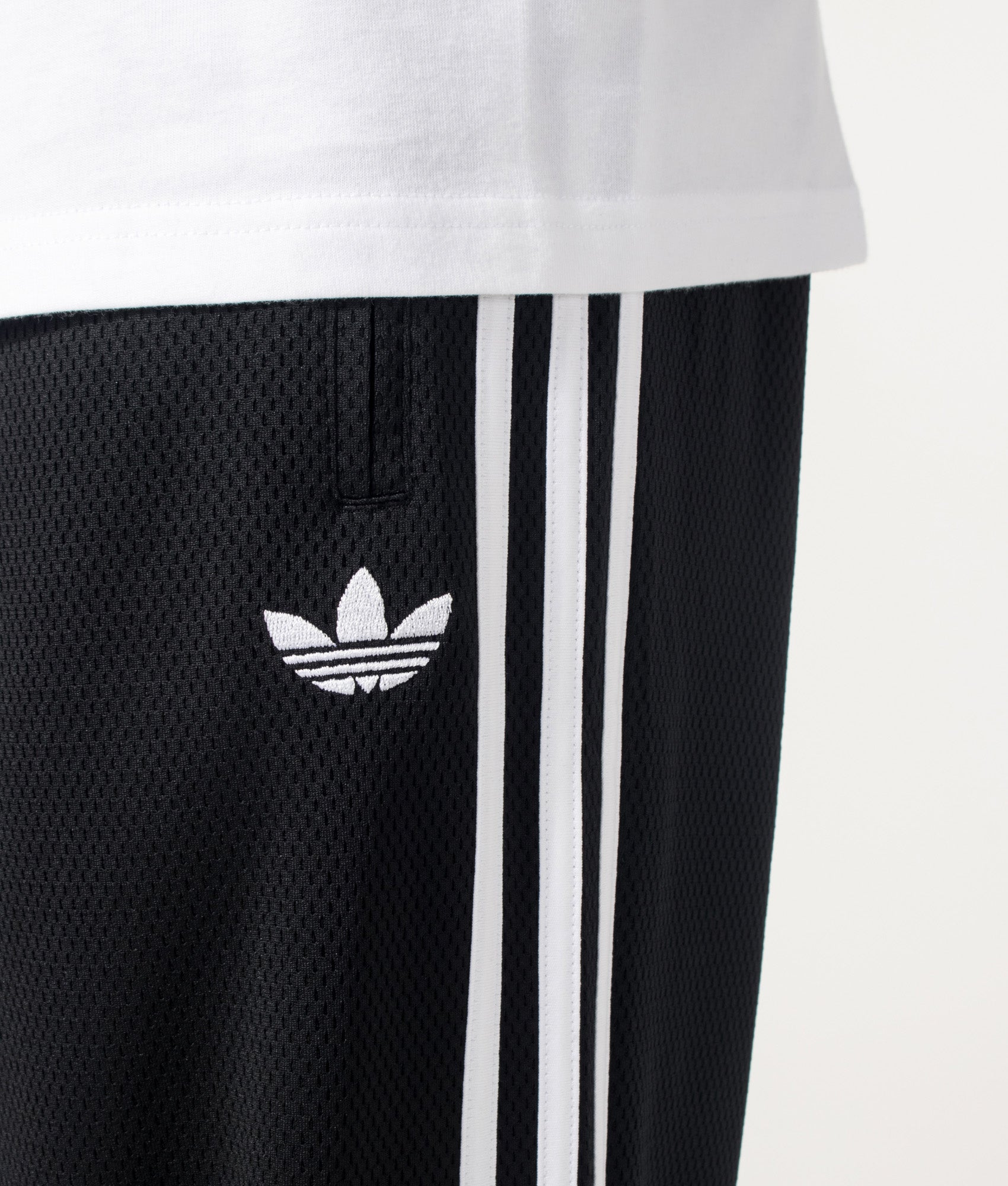 adidas Originals Firebird Track Pants in Black at EQVVS Menswear. Detail shot.