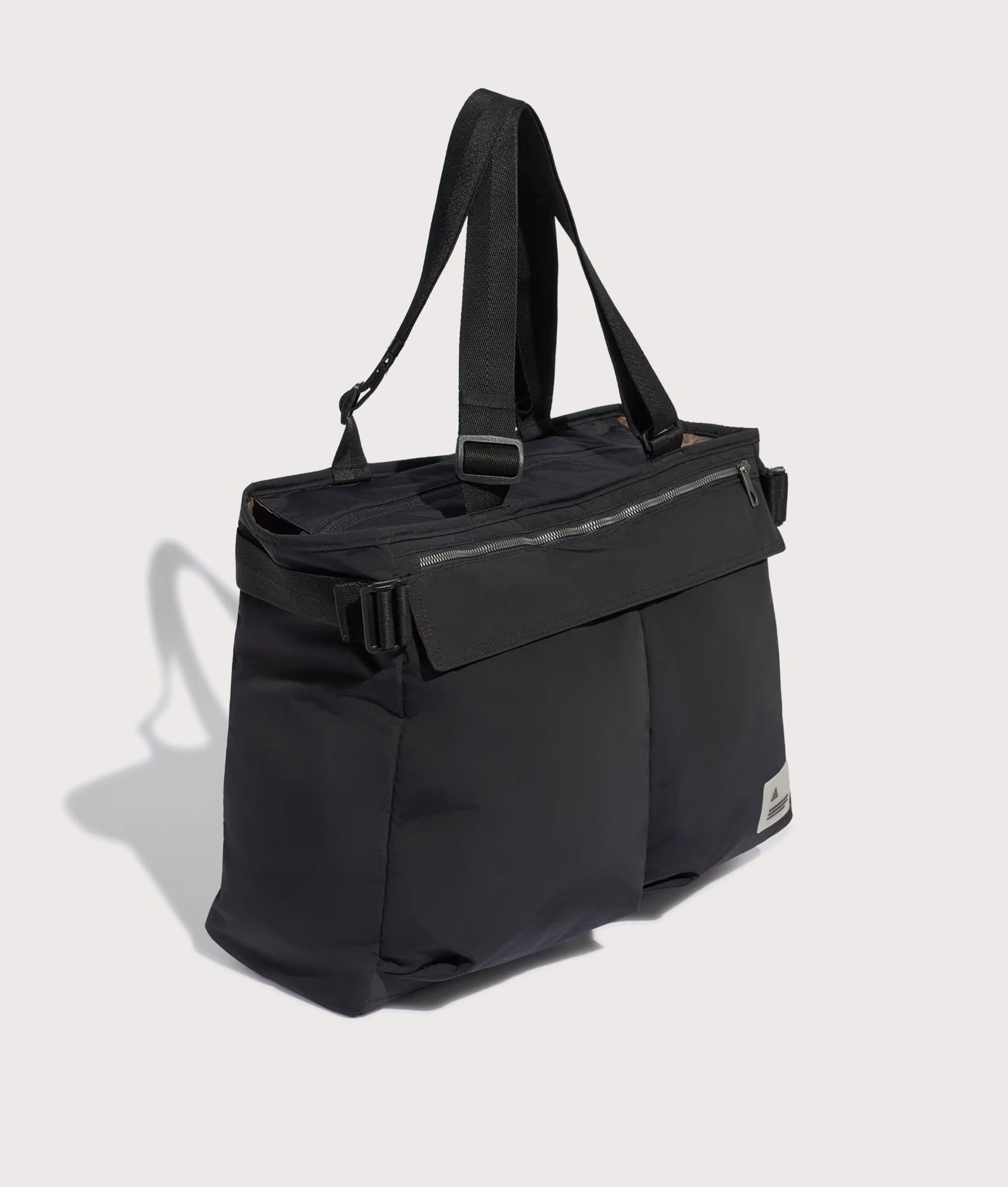 adidas Originals City Tech Tote Bag in Black at EQVVS Menswear. Angled front shot.