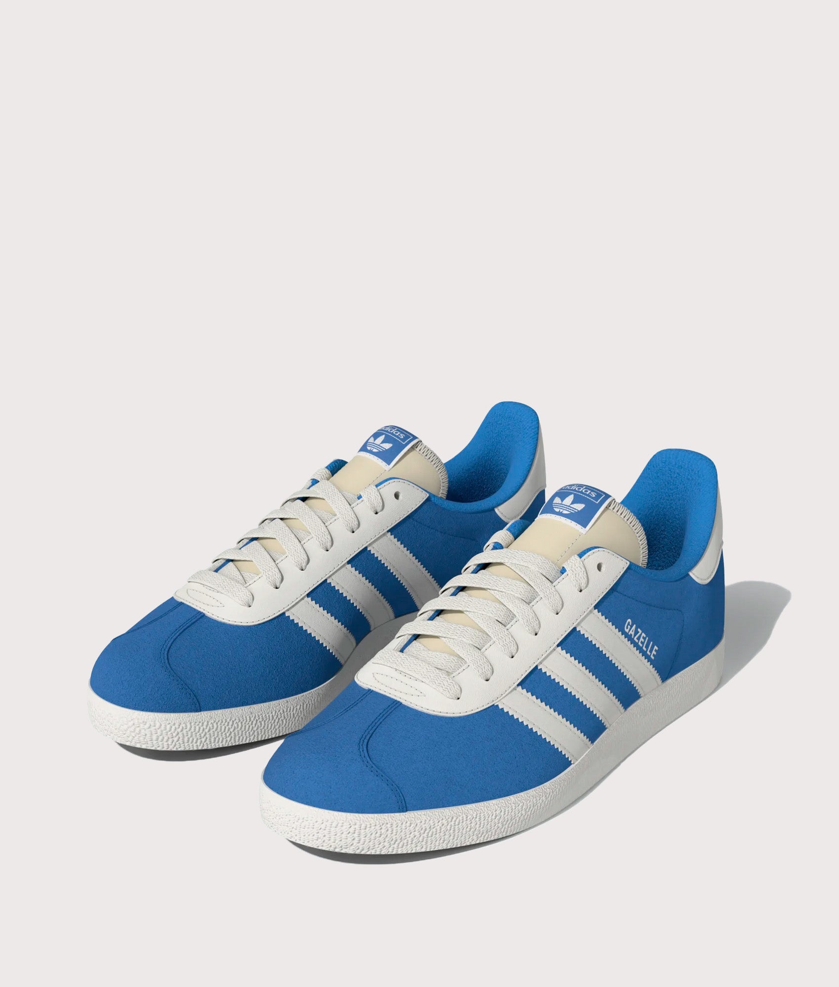 adidas Originals Gazelle Trainers in Bright Blue and Off White at EQVVS Menswear. Angled front shot.