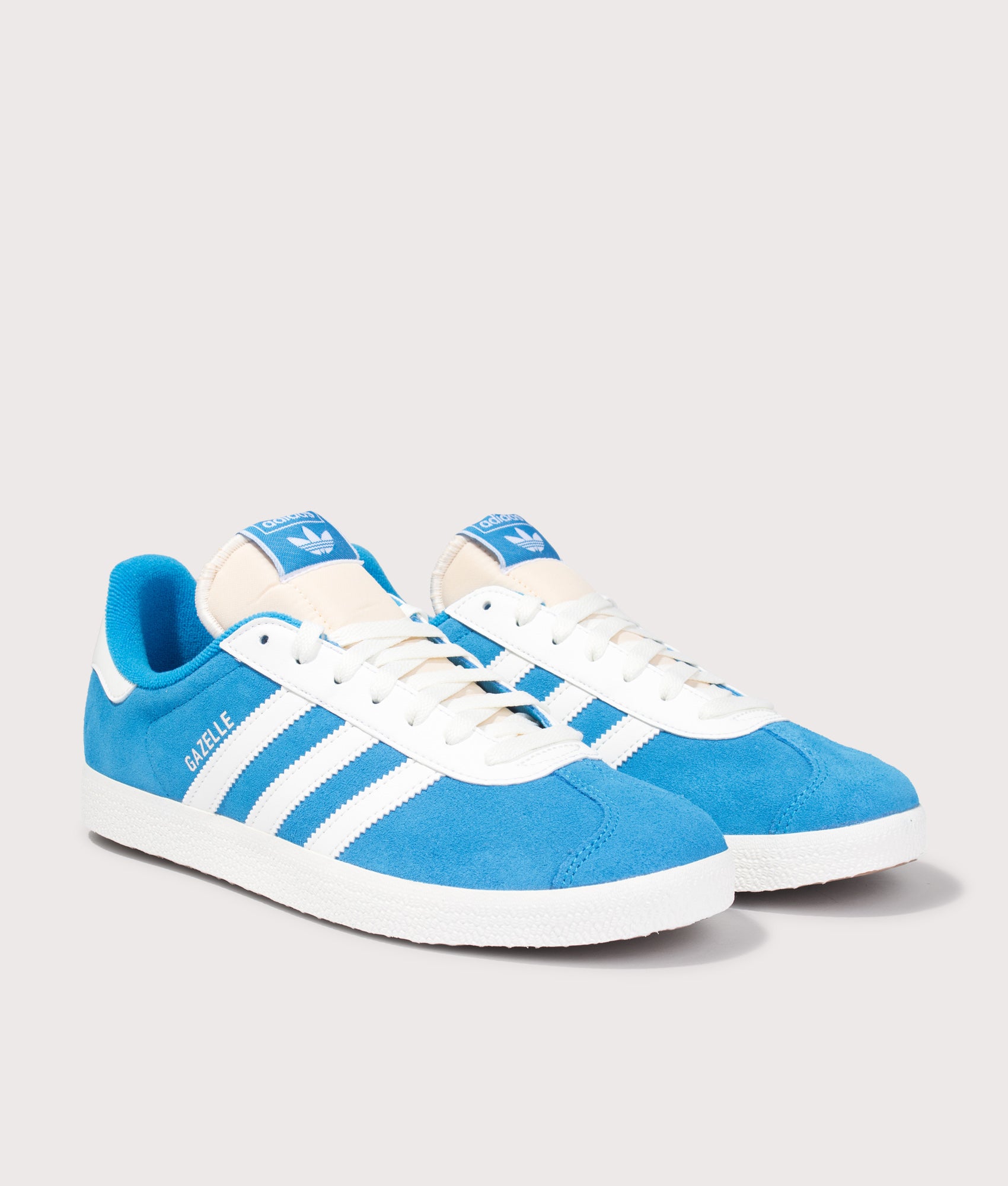 adidas Originals Gazelle Trainers in Bright Blue and Off White at EQVVS Menswear. Angled front shot.