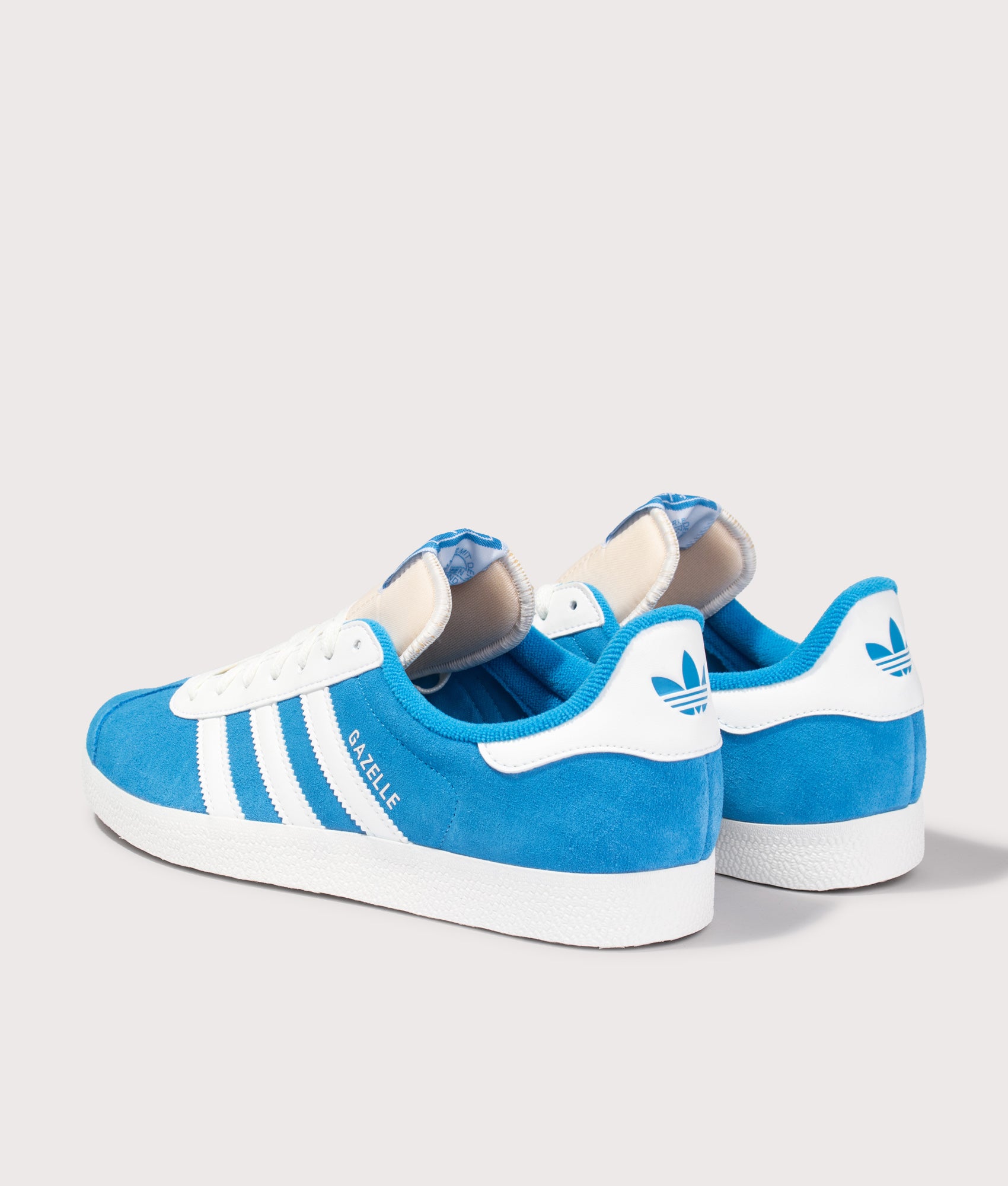 adidas Originals Gazelle Trainers in Bright Blue and Off White at EQVVS Menswear. Angled back shot.