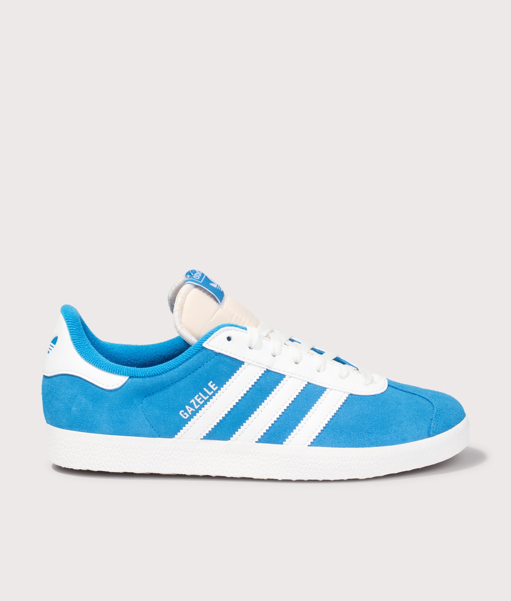 adidas Originals Gazelle Trainers in Bright Blue and Off White at EQVVS Menswear. Side shot.