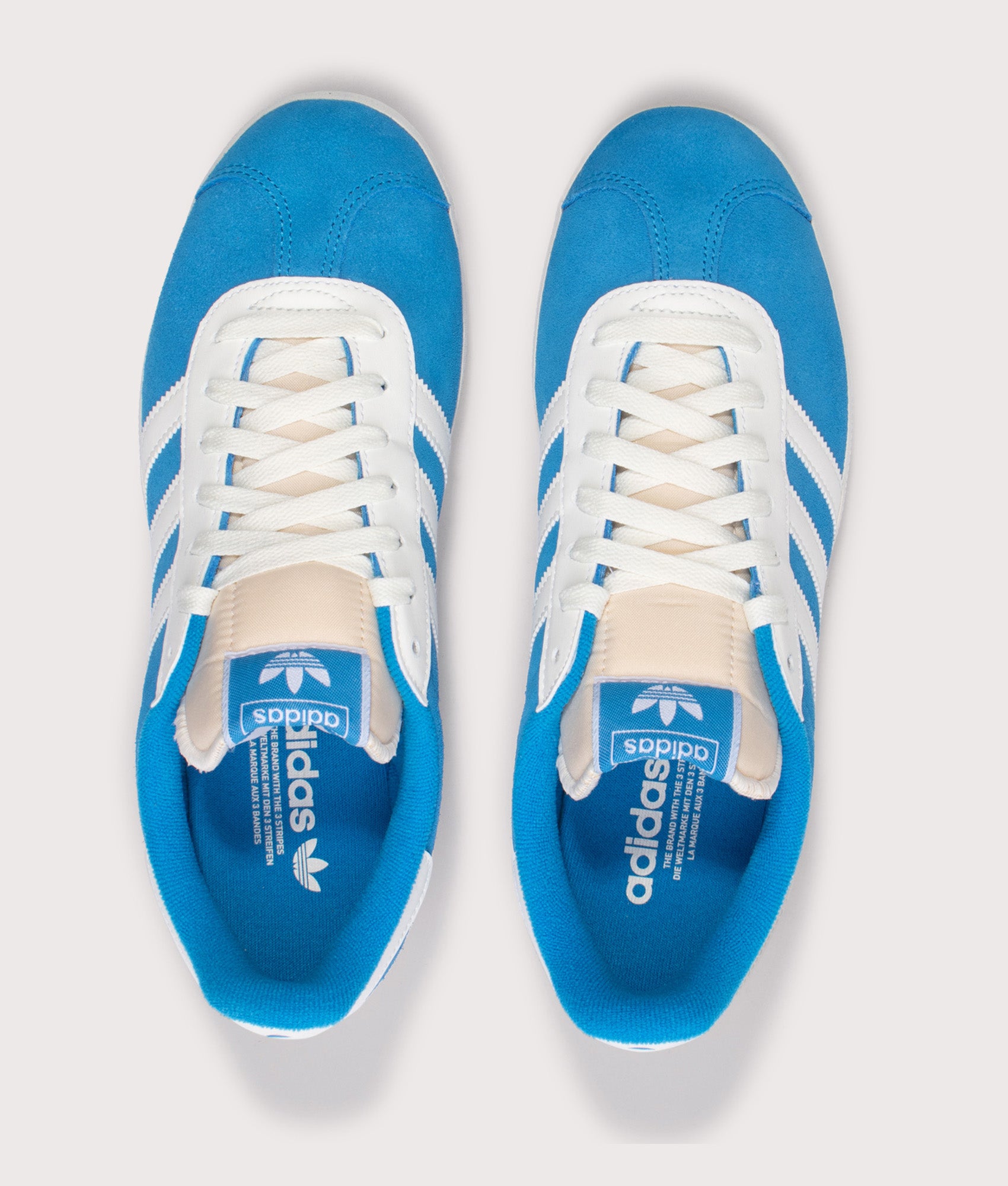 adidas Originals Gazelle Trainers in Bright Blue and Off White at EQVVS Menswear. Front shot.