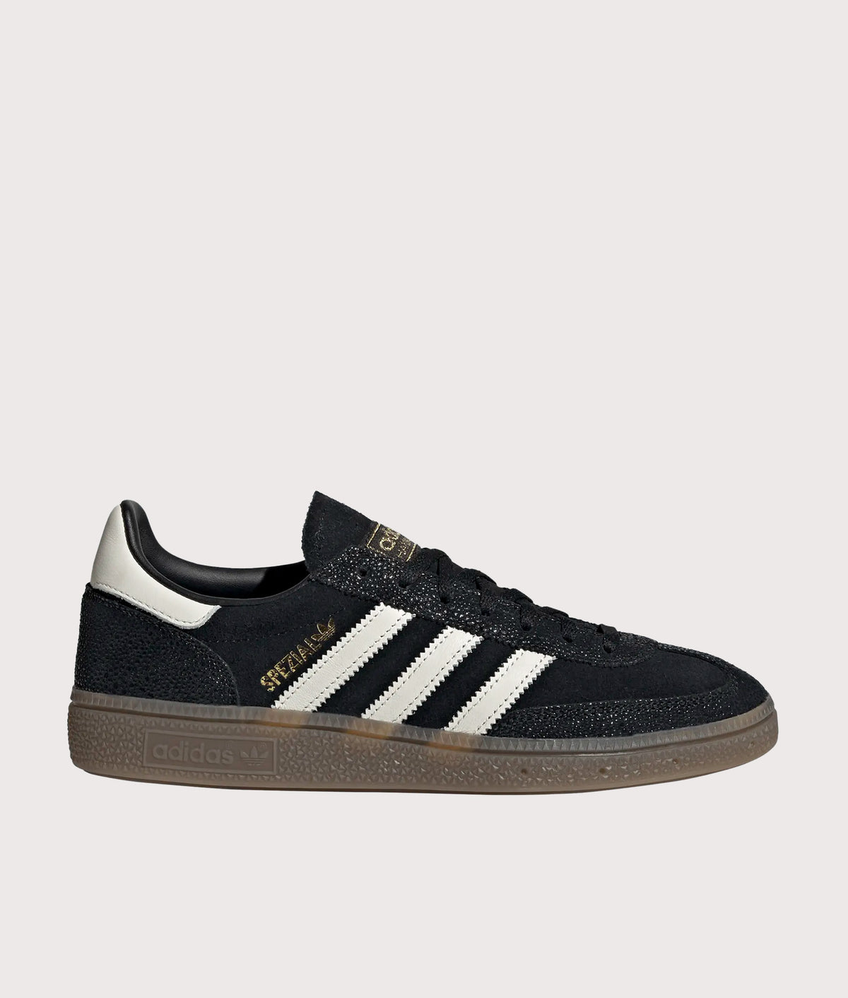 adidas Originals Handball Spezial Trainers in Core Black, Cloud White and Gold Metallic at EQVVS Menswear. Side shot.