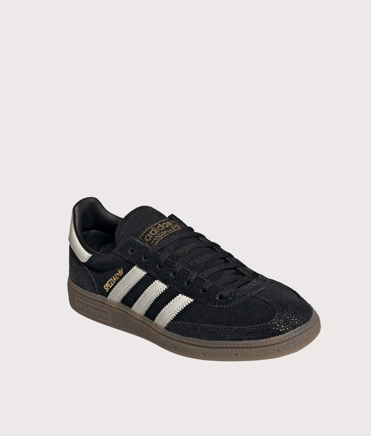 adidas Originals Handball Spezial Trainers in Core Black, Cloud White and Gold Metallic at EQVVS Menswear. Angled front shot.