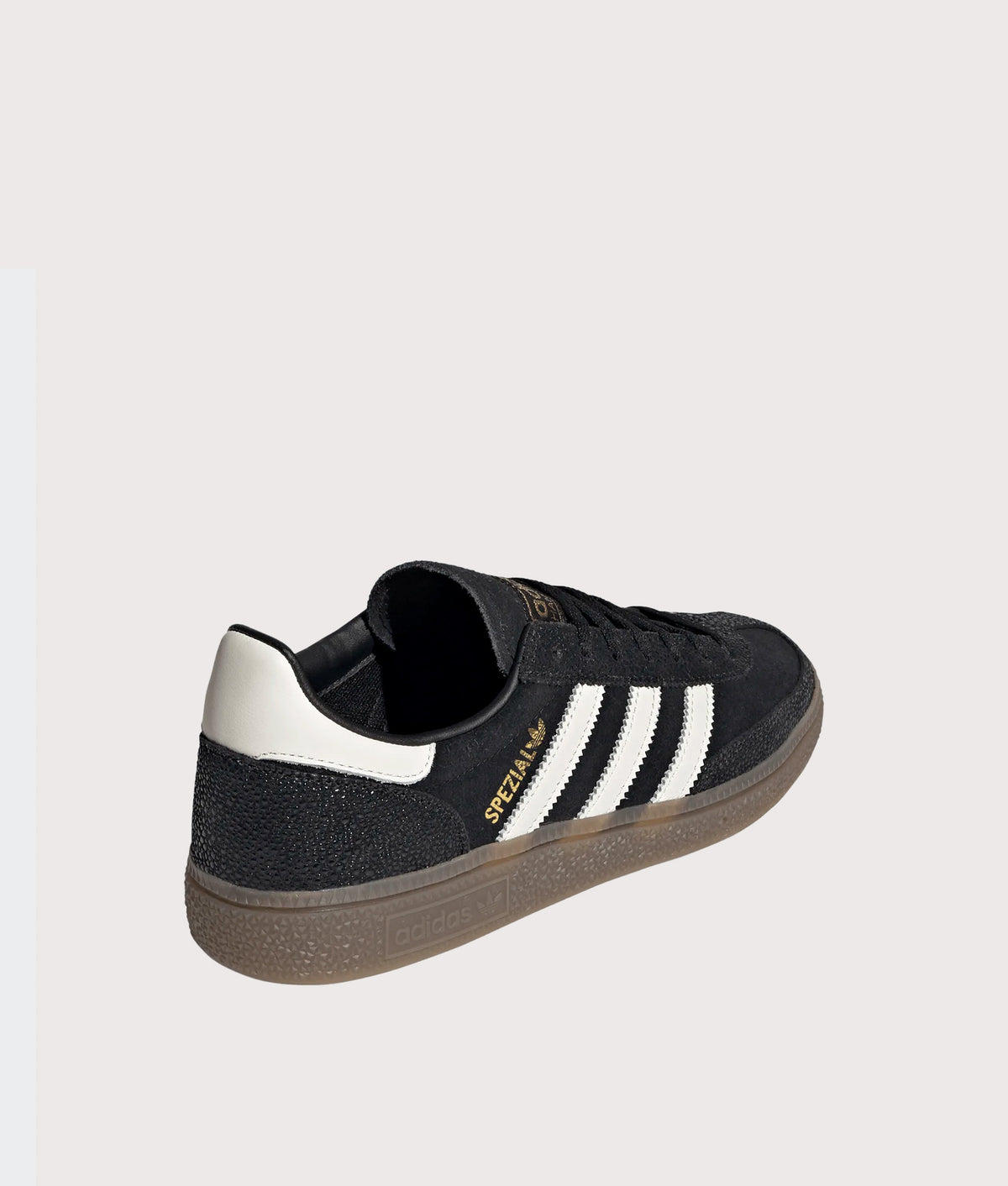 adidas Originals Handball Spezial Trainers in Core Black, Cloud White and Gold Metallic at EQVVS Menswear. Angled back shot.
