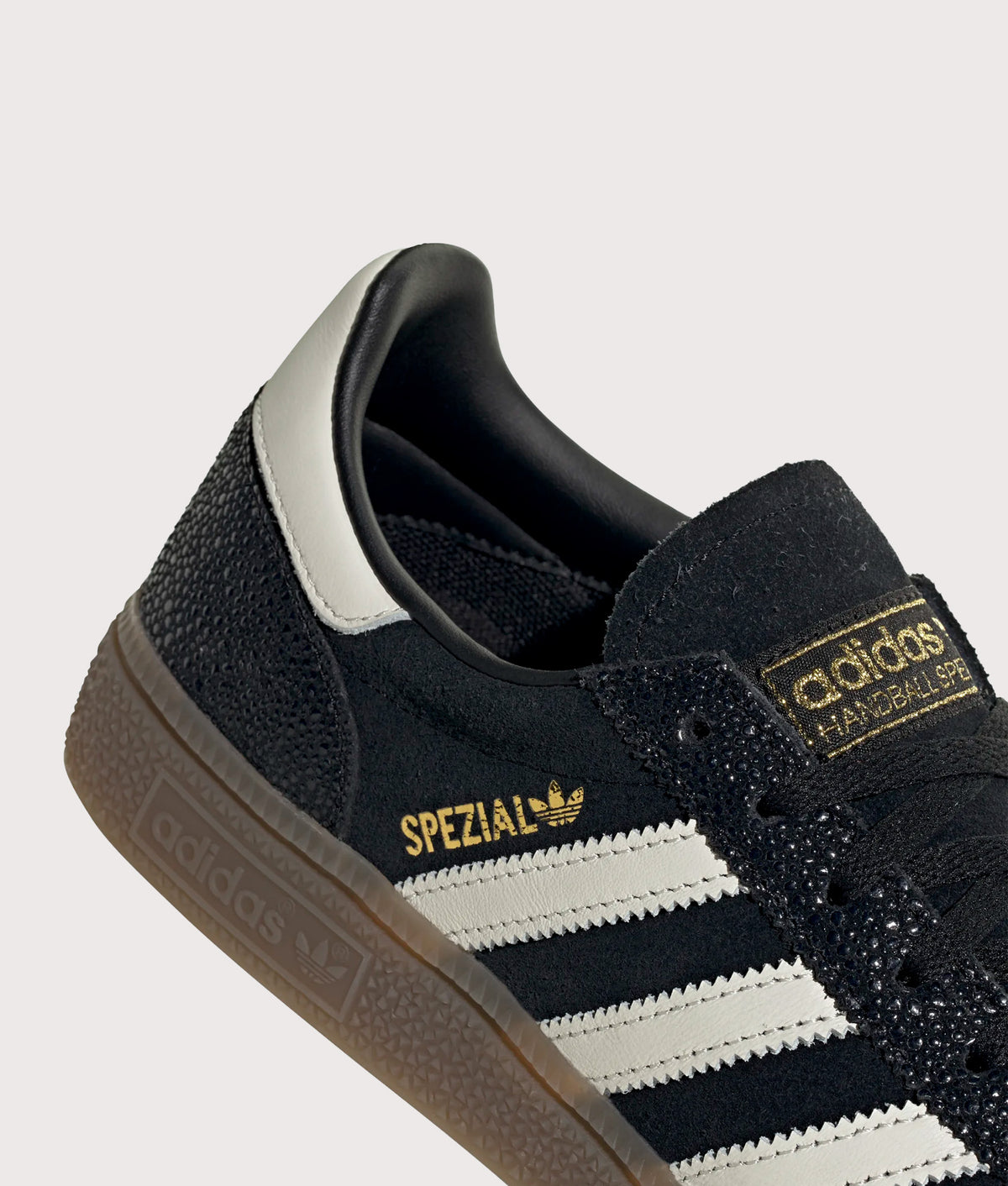 adidas Originals Handball Spezial Trainers in Core Black, Cloud White and Gold Metallic at EQVVS Menswear. Detail shot.