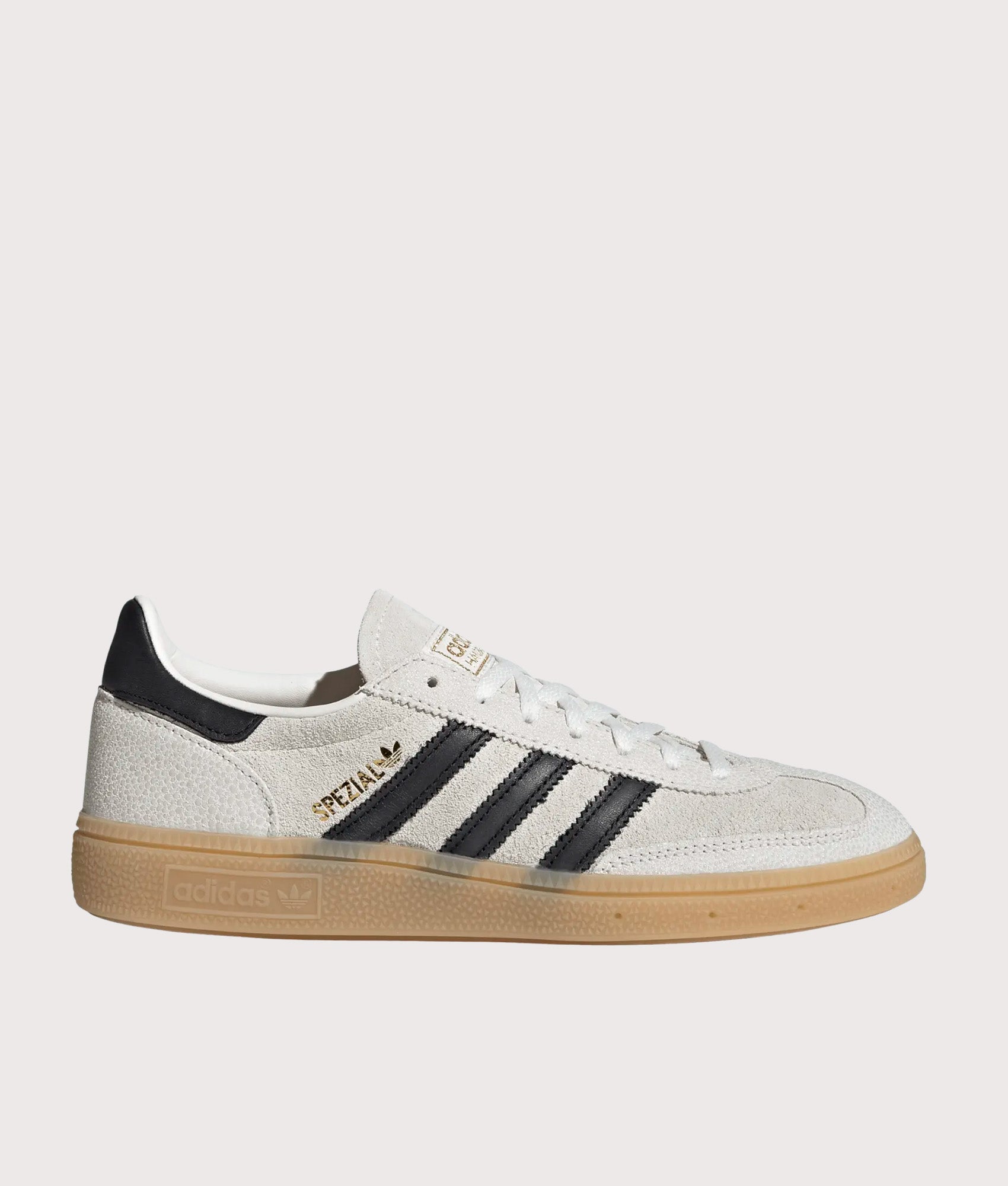 adidas Originals Handball Spezial Trainers in Cloud White, Core Black and Gold Metallic at EQVVS Menswear. Side shot.