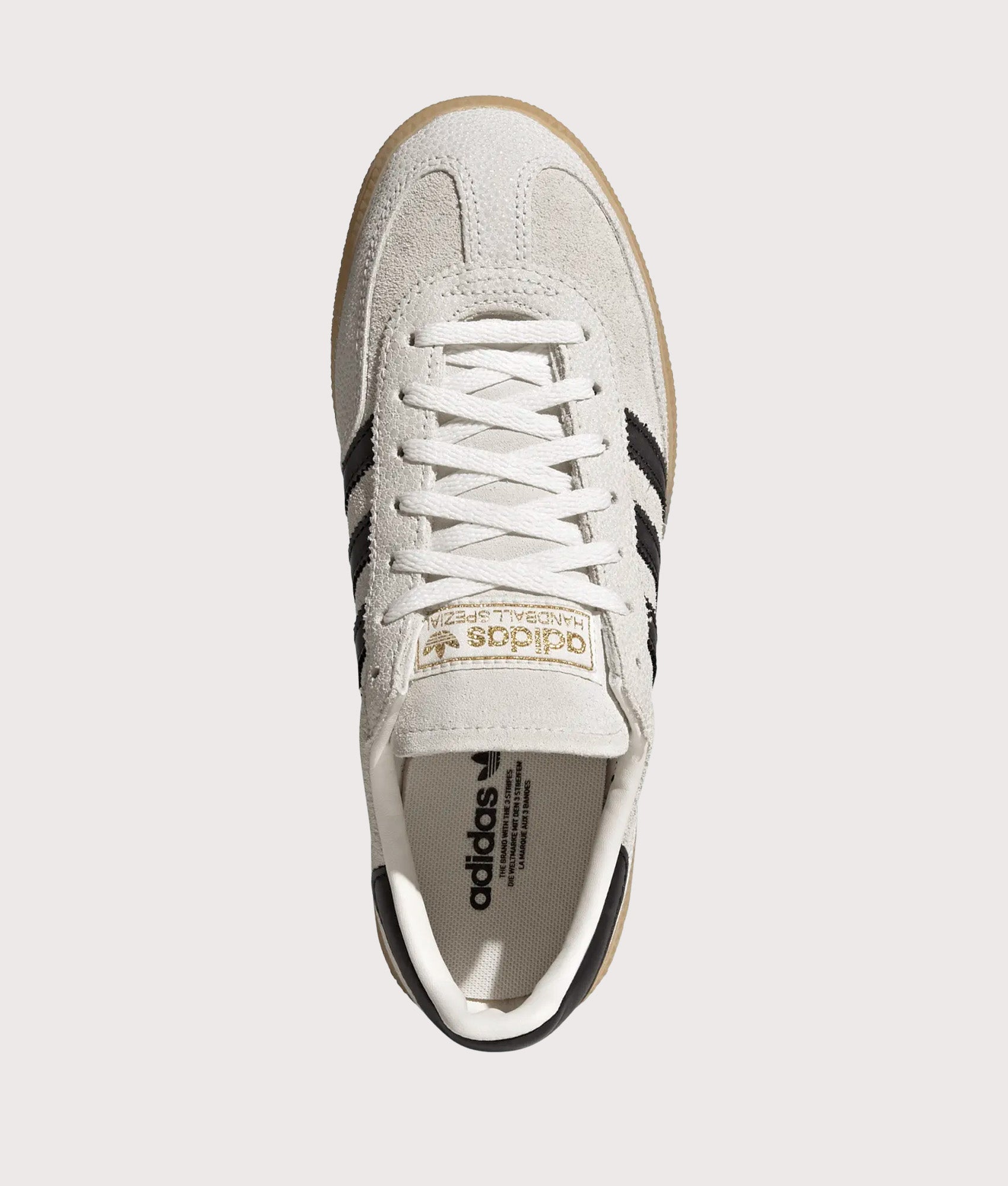 adidas Originals Handball Spezial Trainers in Cloud White, Core Black and Gold Metallic at EQVVS Menswear. Top shot.