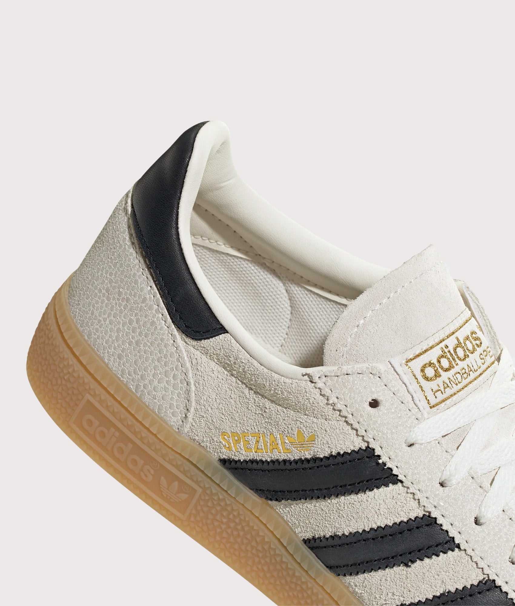 adidas Originals Handball Spezial Trainers in Cloud White, Core Black and Gold Metallic at EQVVS Menswear. Detail shot.