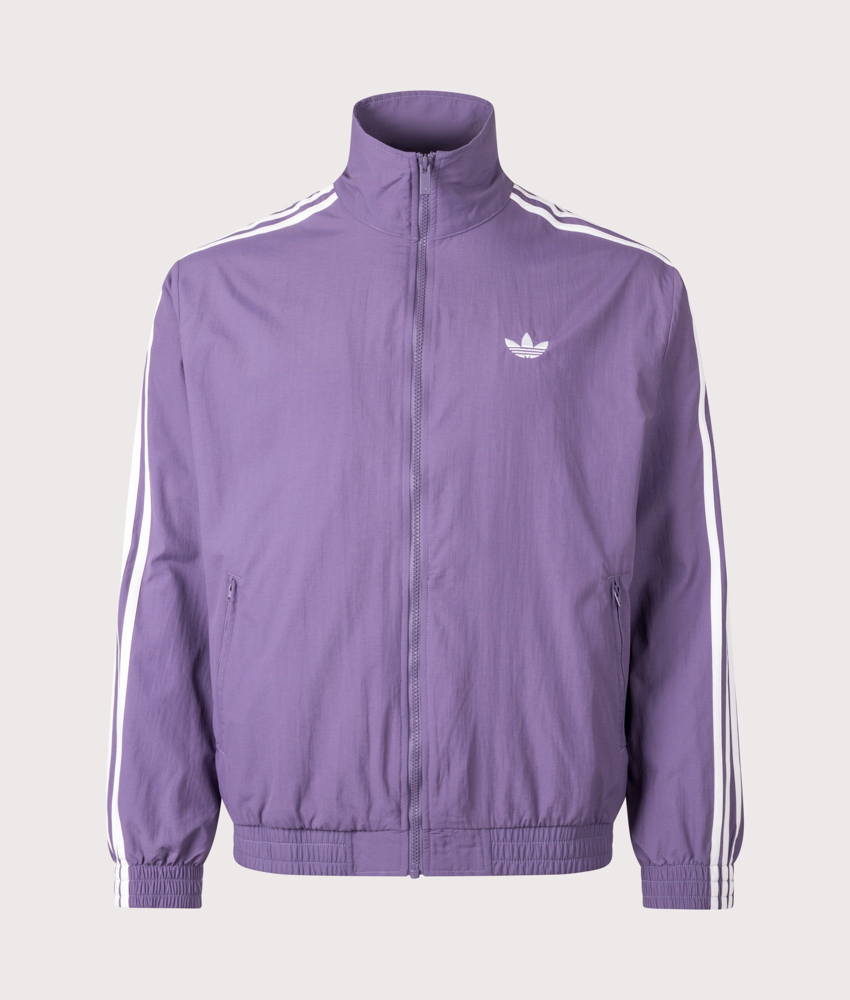 adidas Originals Firebird Woven Track Top in Tech Purple and White at EQVVS Menswear. Front shot.