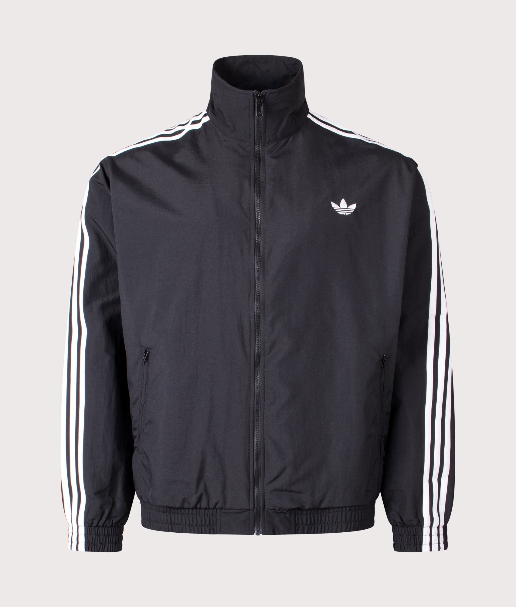 adidas Originals Loose Fit Firebird Woven Track Top in Black at EQVVS Menswear. Front shot.