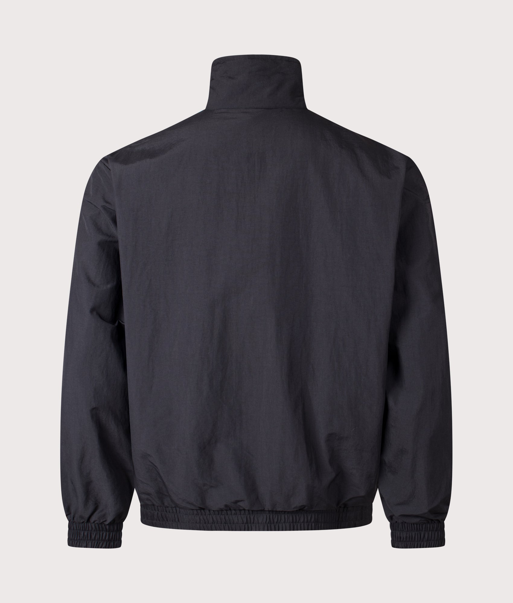 adidas Originals Loose Fit Firebird Woven Track Top in Black at EQVVS Menswear. Back shot.