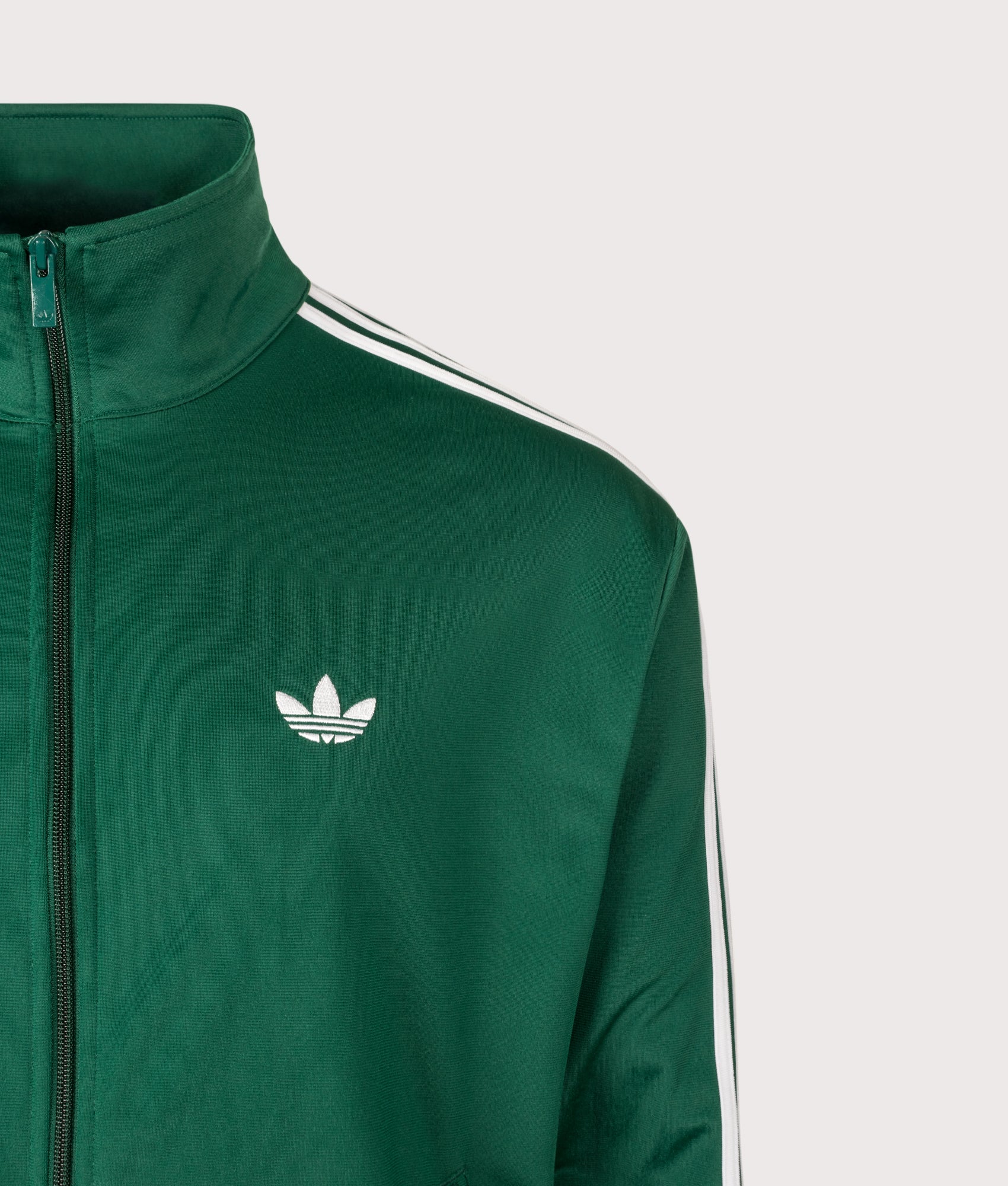 adidas Originals Loose Fit Firebird Track Top in Collegiate Green at EQVVS Menswear. Detail shot.