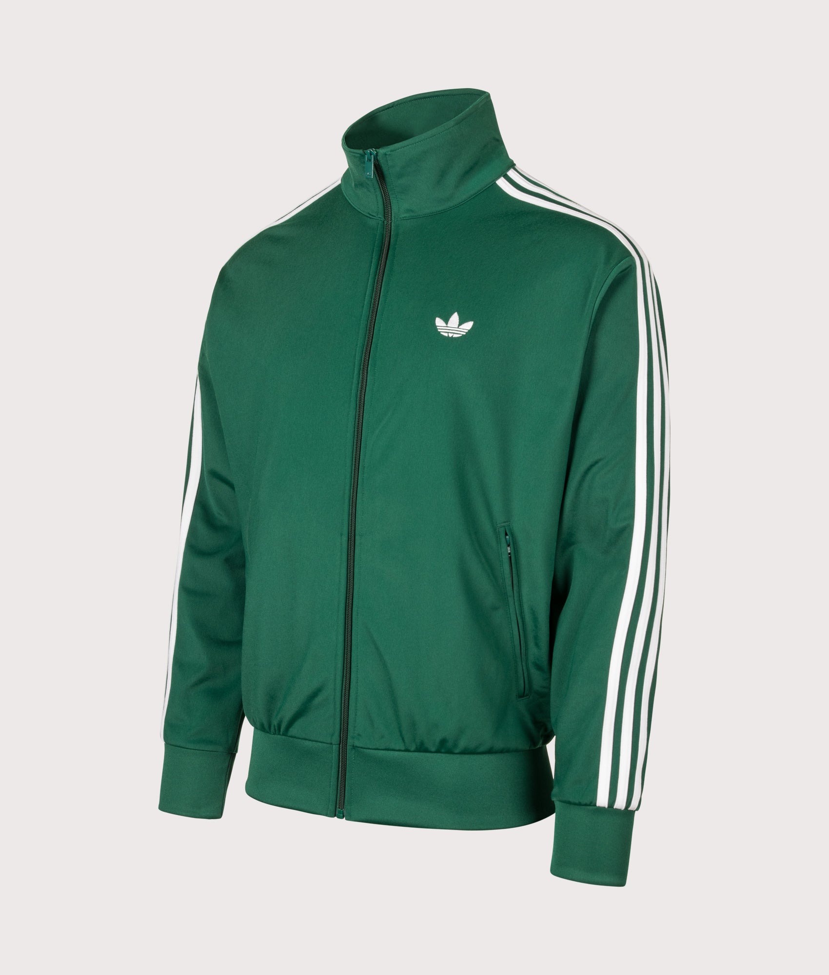 adidas Originals Loose Fit Firebird Track Top in Collegiate Green at EQVVS Menswear. Angled front shot.