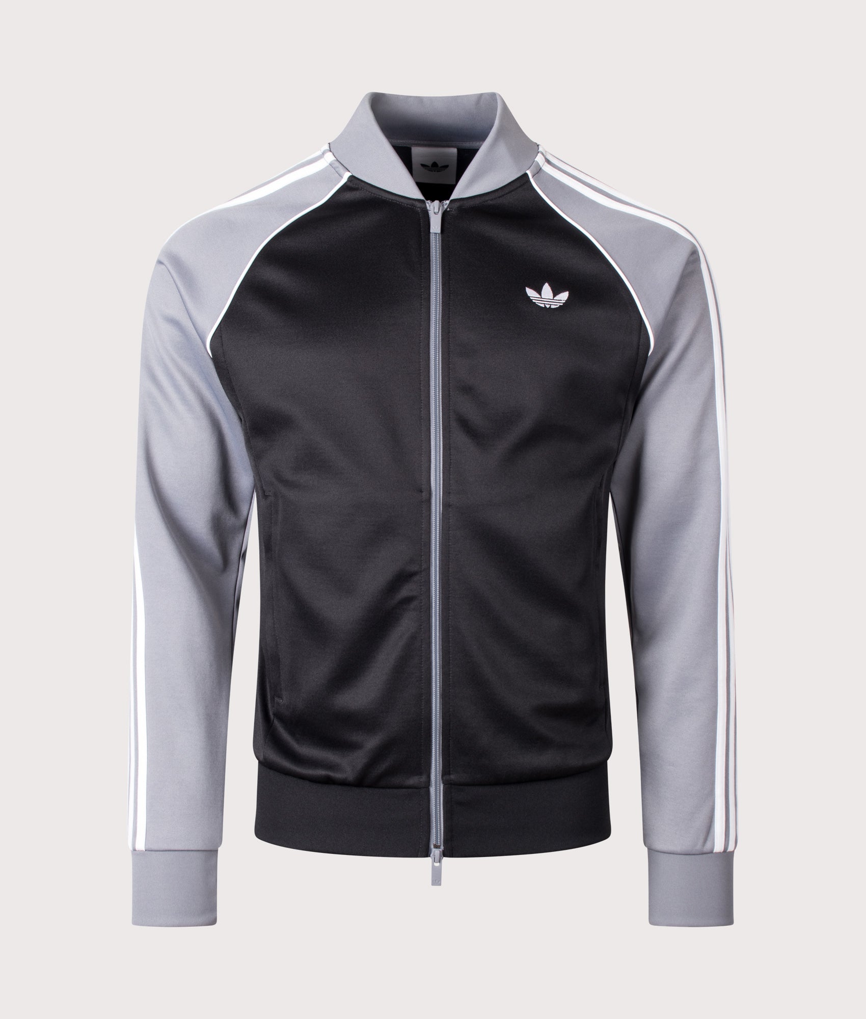 adidas Originals Slim Fit SST Track Top in Black, Grey and White at EQVVS Menswear. Front shot.