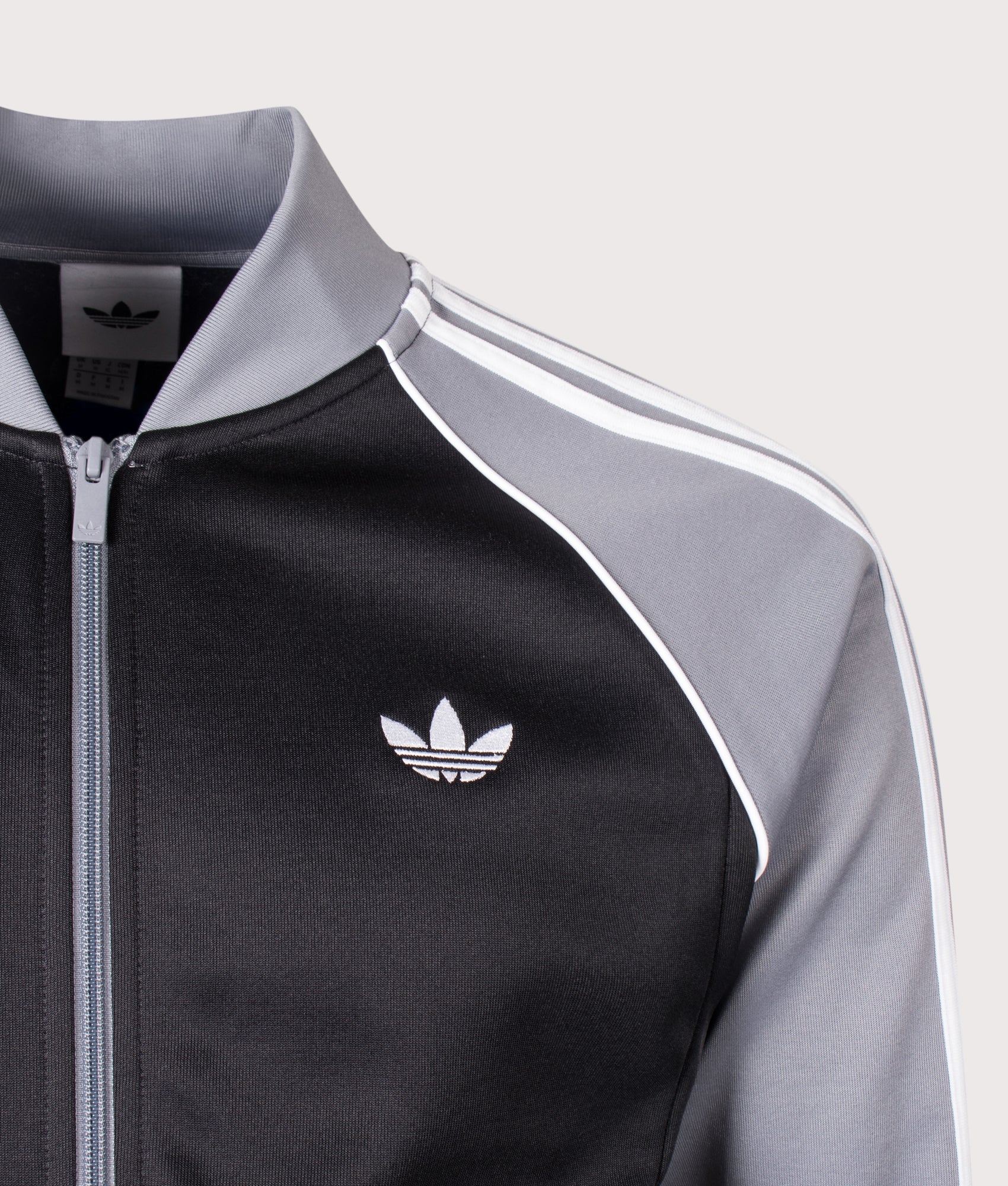 adidas Originals Slim Fit SST Track Top in Black, Grey and White at EQVVS Menswear. Detail shot.