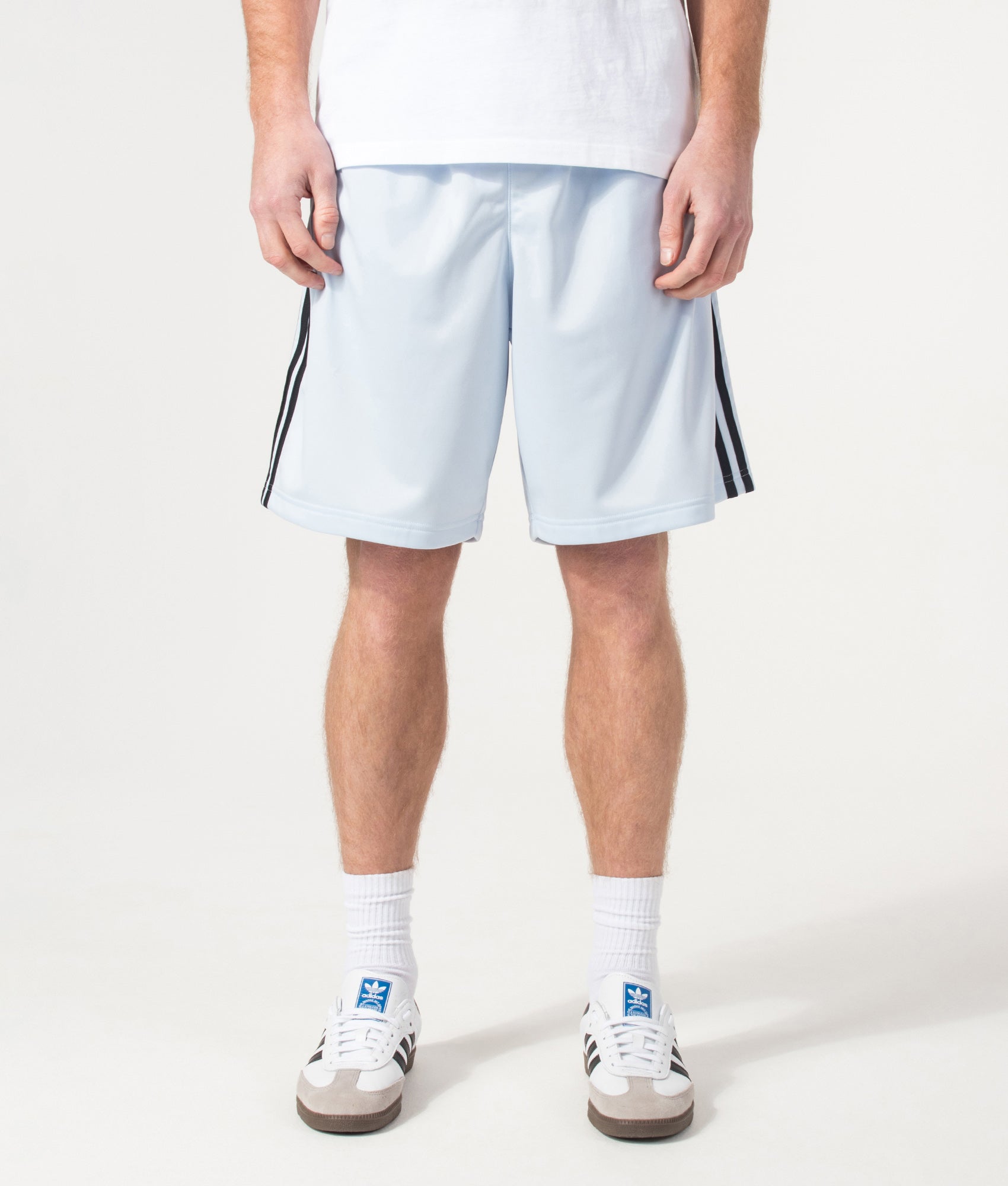 adidas Originals Firebird Shorts in Crystal Sky at EQVVS Menswear. Model front shot.