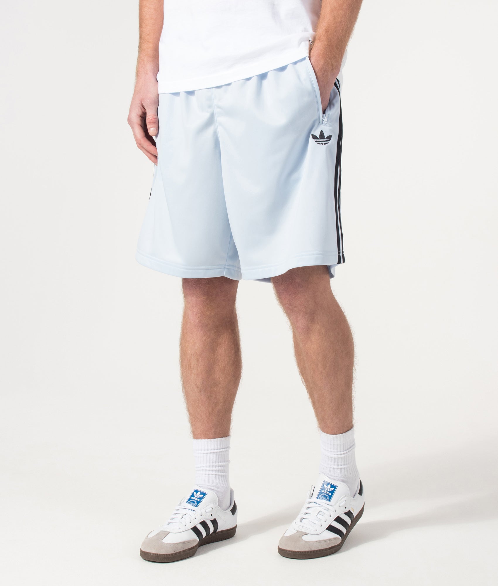 adidas Originals Firebird Shorts in Crystal Sky at EQVVS Menswear. Angled model front shot.