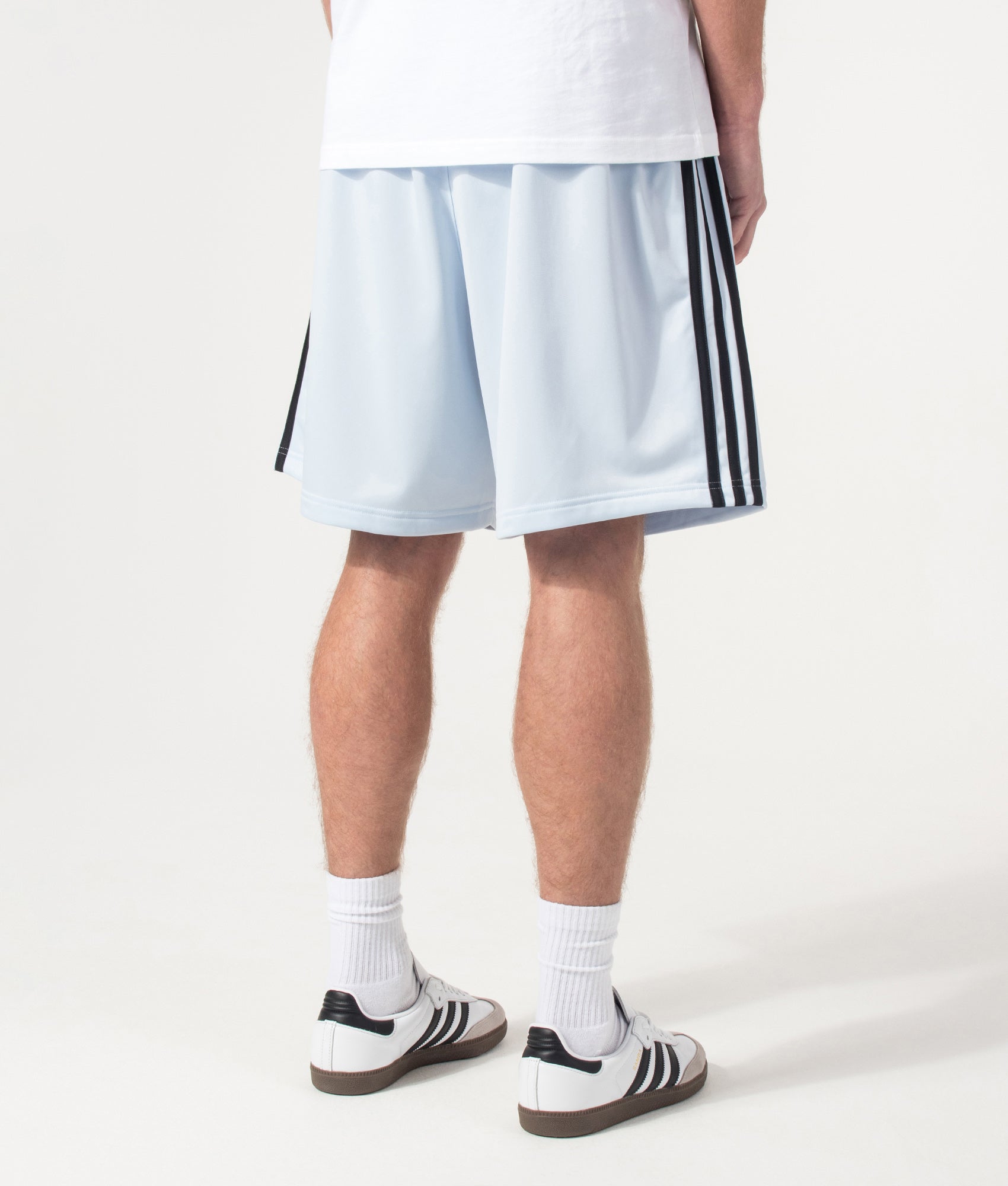 adidas Originals Firebird Shorts in Crystal Sky at EQVVS Menswear. Angled model front shot.