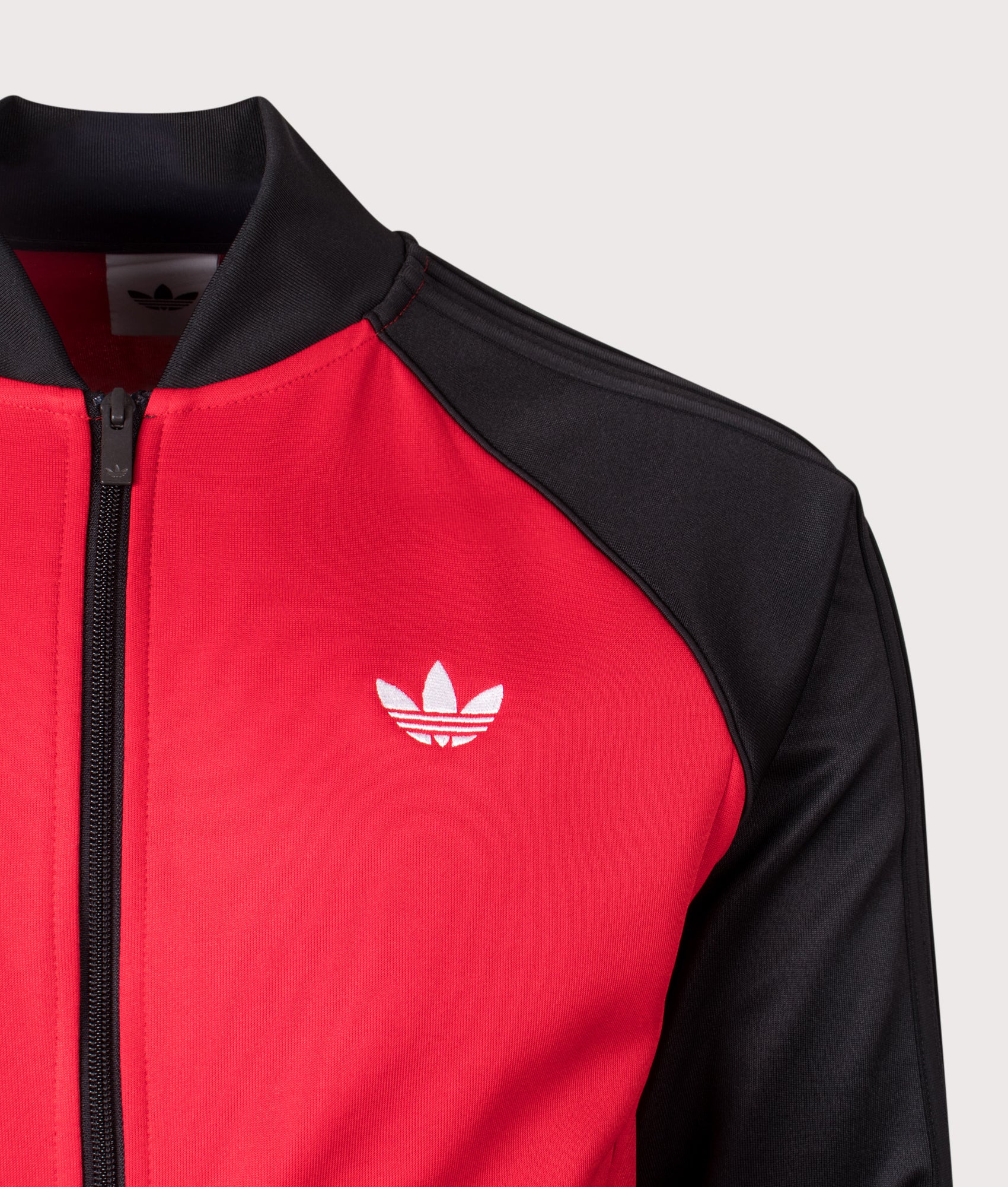 adidas Originals SST Track Top in Better Scarlet at EQVVS Menswear. Detail shot.