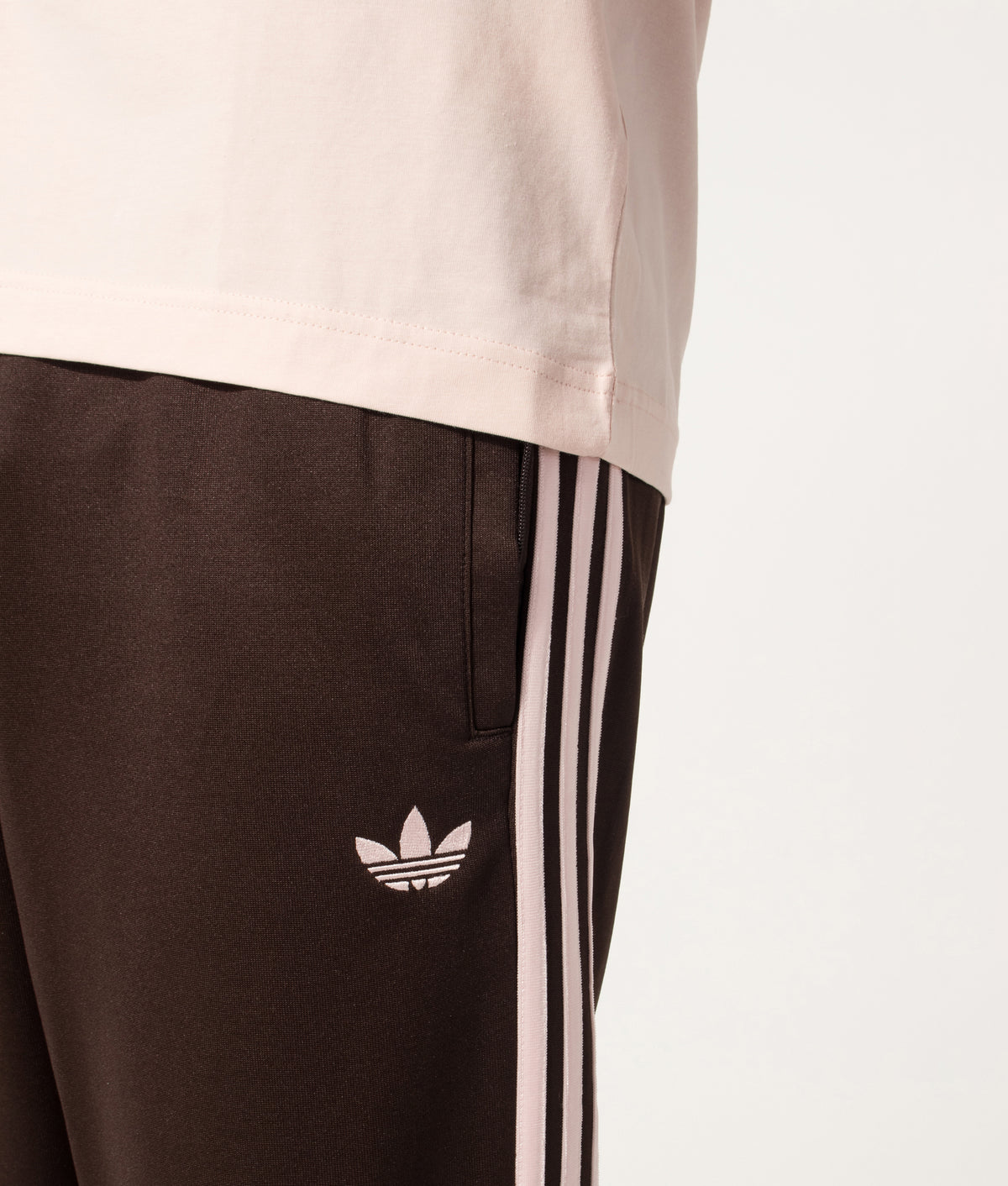 adidas Originals Regular Fit SST Track Pants in Aurora Coffee at EQVVS Menswear. Detail shot.