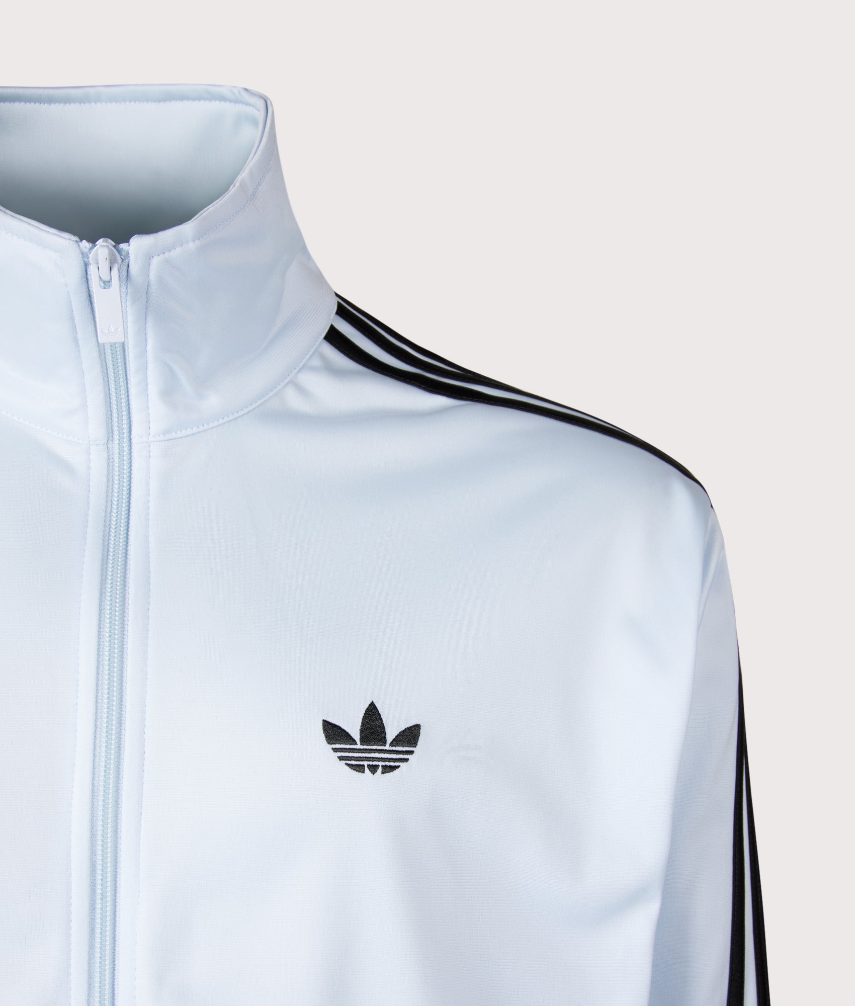 adidas Originals Loose Fit Firebird Track Top in Crystal Sky at EQVVS Menswear. Detail shot.