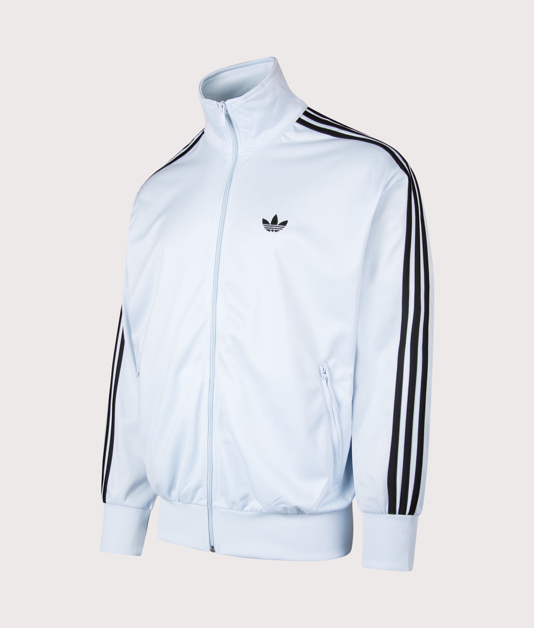 adidas Originals Loose Fit Firebird Track Top in Crystal Sky at EQVVS Menswear. Angled front shot.