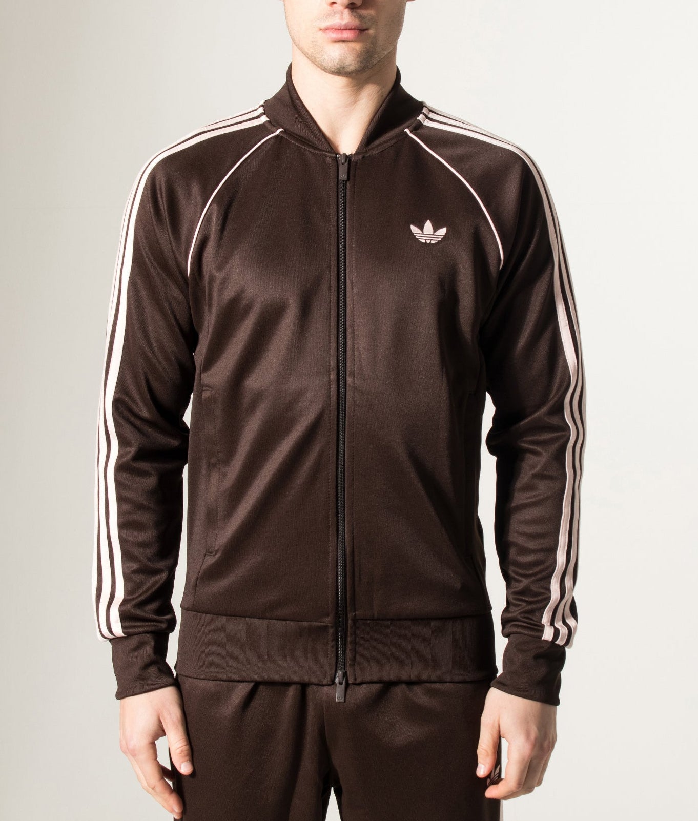 adidas Originals SST Track Top in Aurora Coffee at EQVVS Menswear. Model front shot.