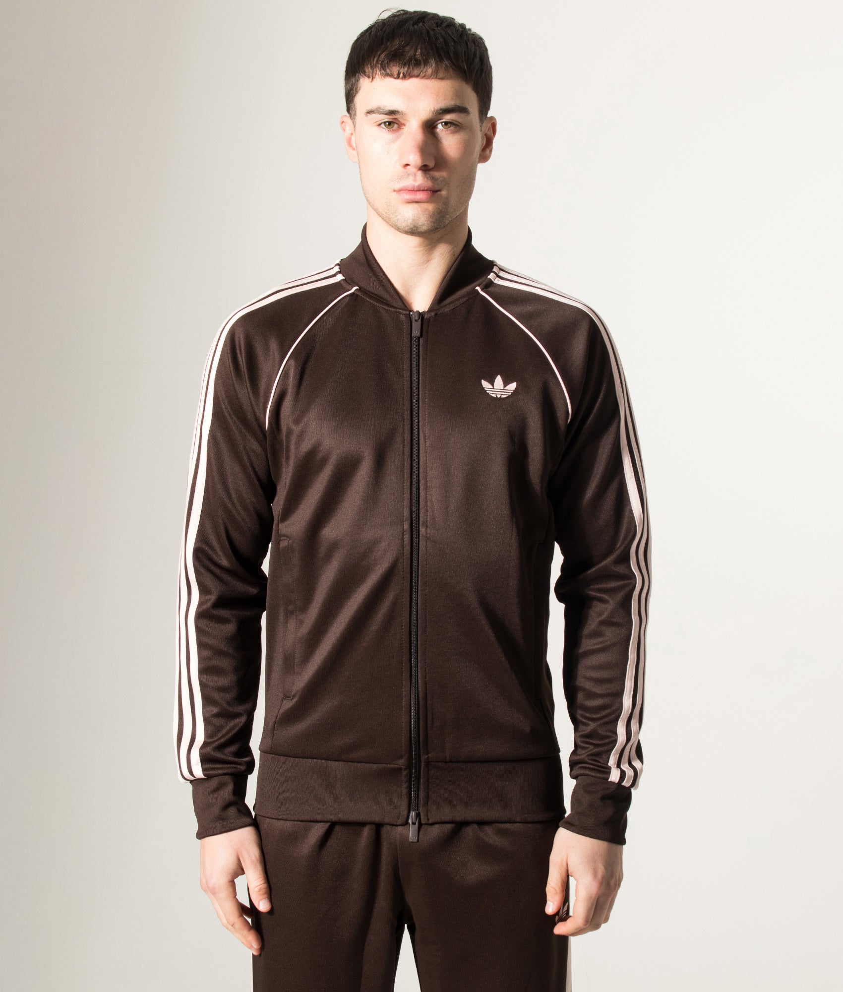 adidas Originals SST Track Top in Aurora Coffee at EQVVS Menswear. Model front shot.