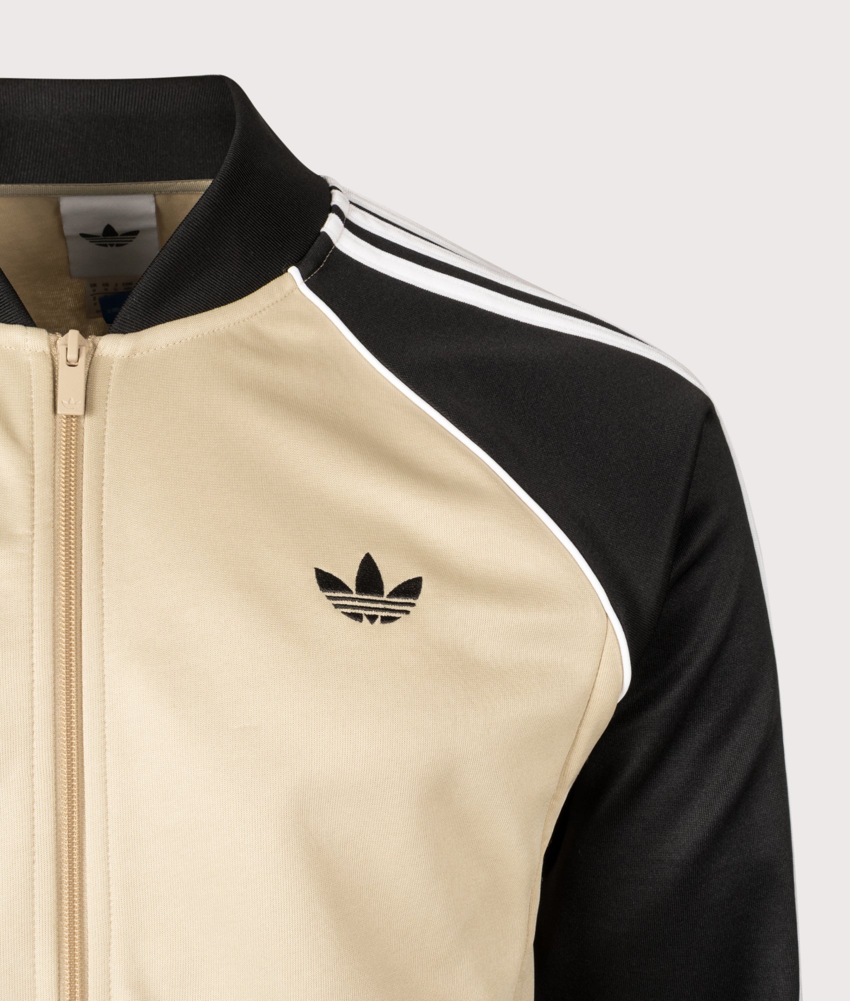 adidas Originals SST Track Top in Stone Khaki at EQVVS Menswear. Detail shot.