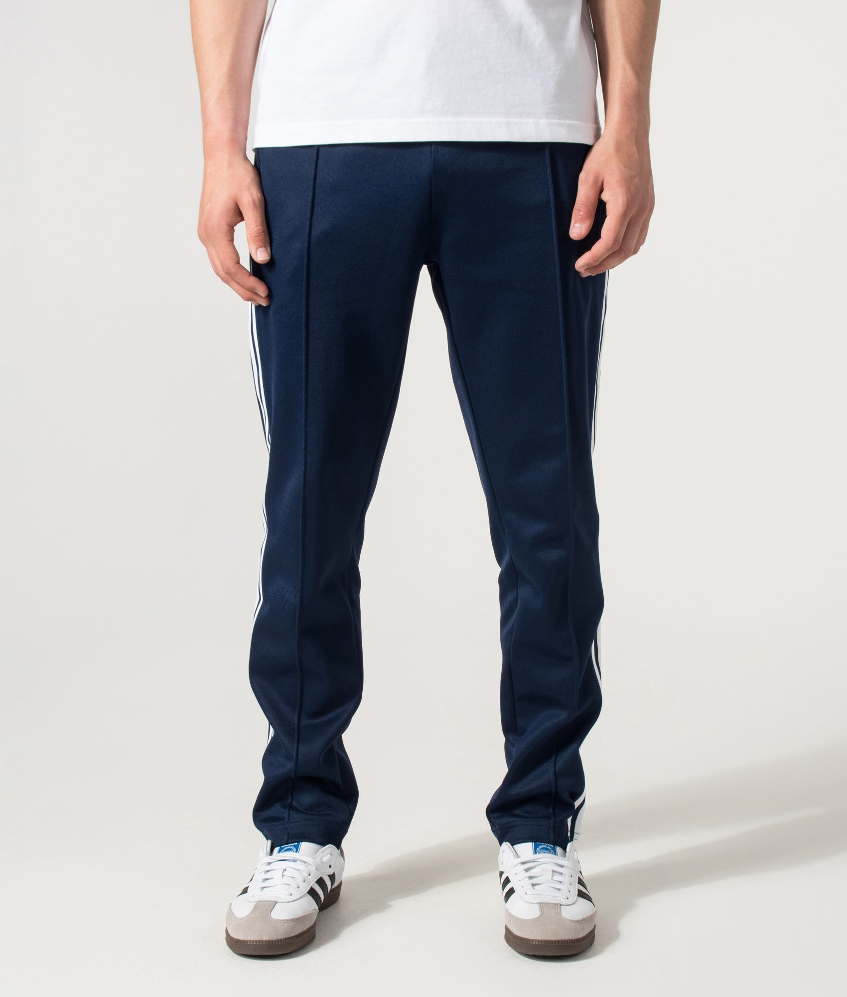 adidas Originals Slim Fit Beckenbauer Track Pants in Night Indigo at EQVVS Menswear. Front shot.