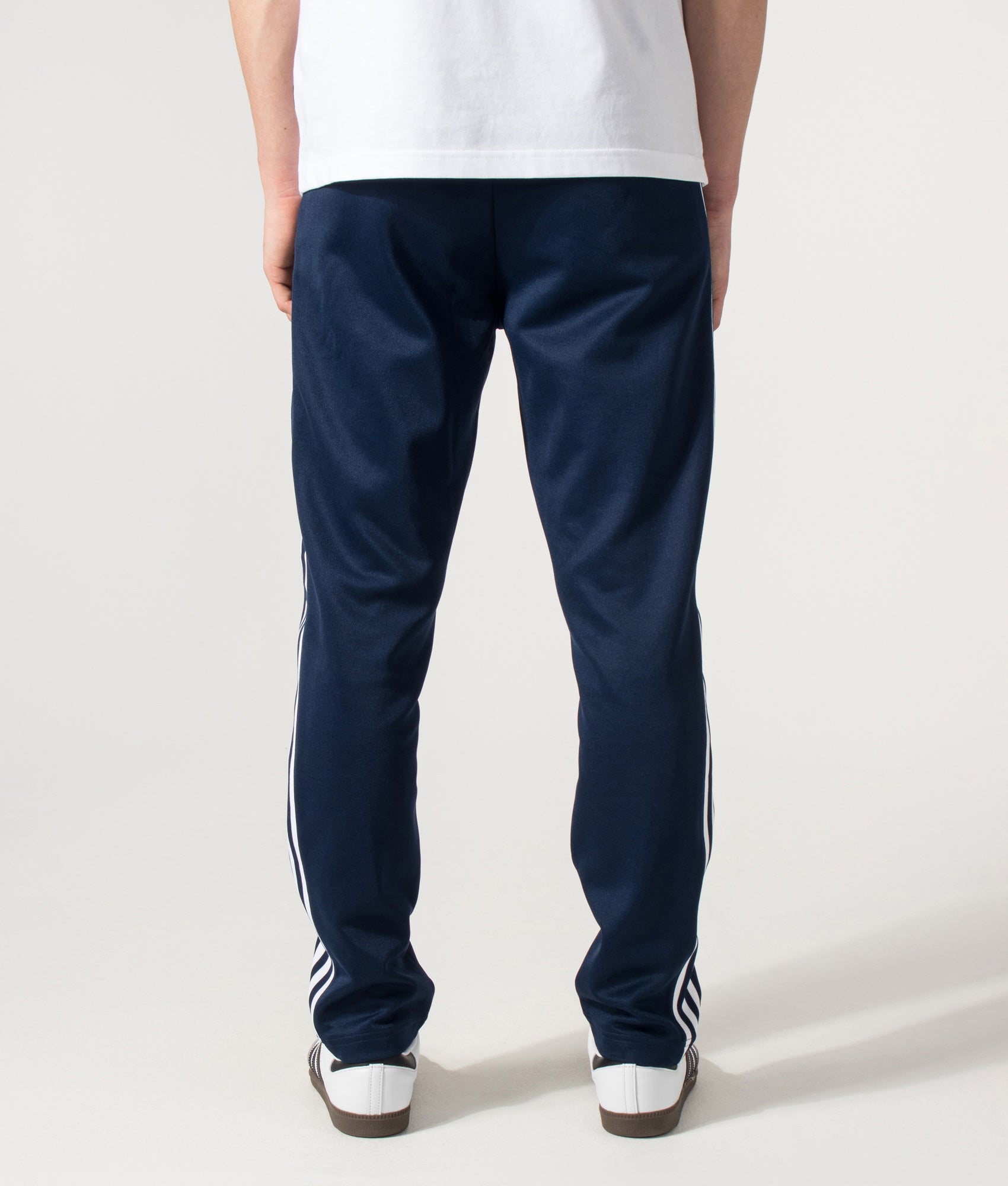 adidas Originals Slim Fit Beckenbauer Track Pants in Night Indigo at EQVVS Menswear. Back shot.