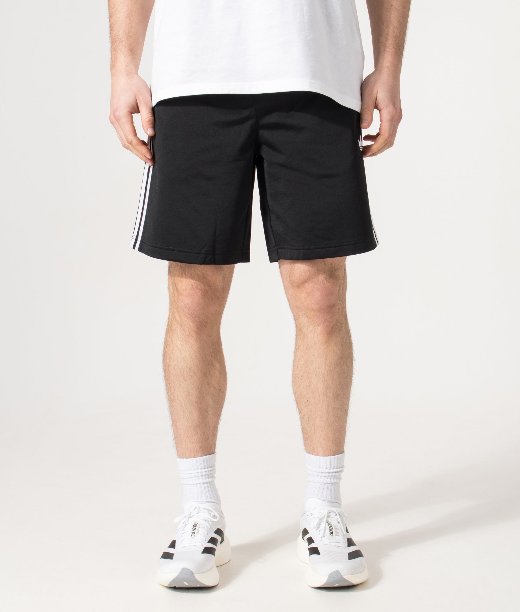 adidas Originals Firebird Shorts in Black at EQVVS Menswear. Front model shot.
