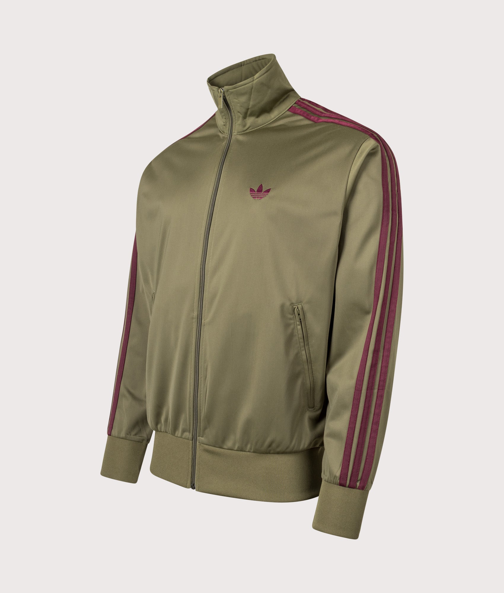 adidas Originals Firebird Track Top in Focus Olive and Maroon at EQVVS menswear. Angled front shot.